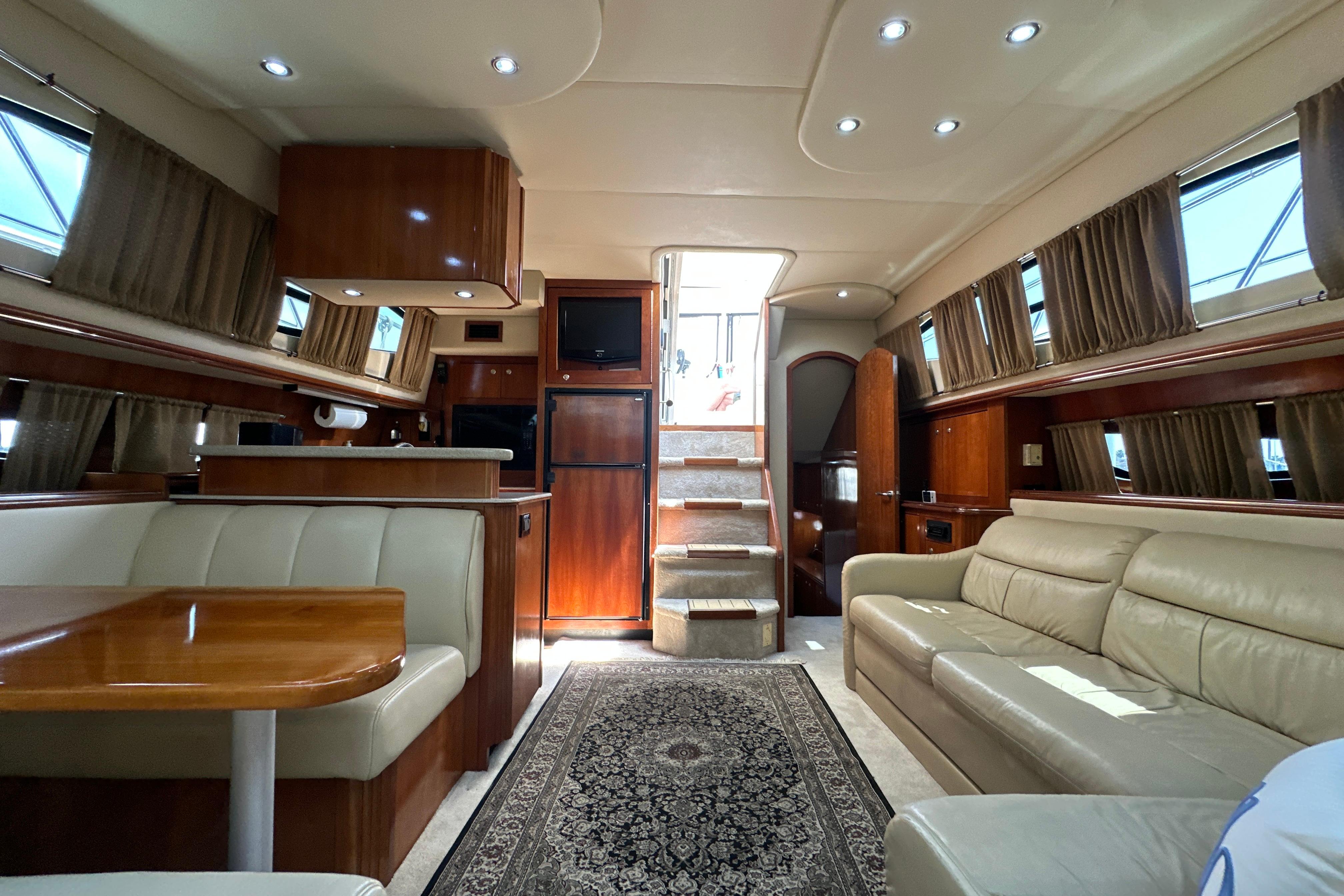 Luxurious interior of 2004 Cruisers Yachts 405 Express Motoryacht with elegant seating and wood finishes.