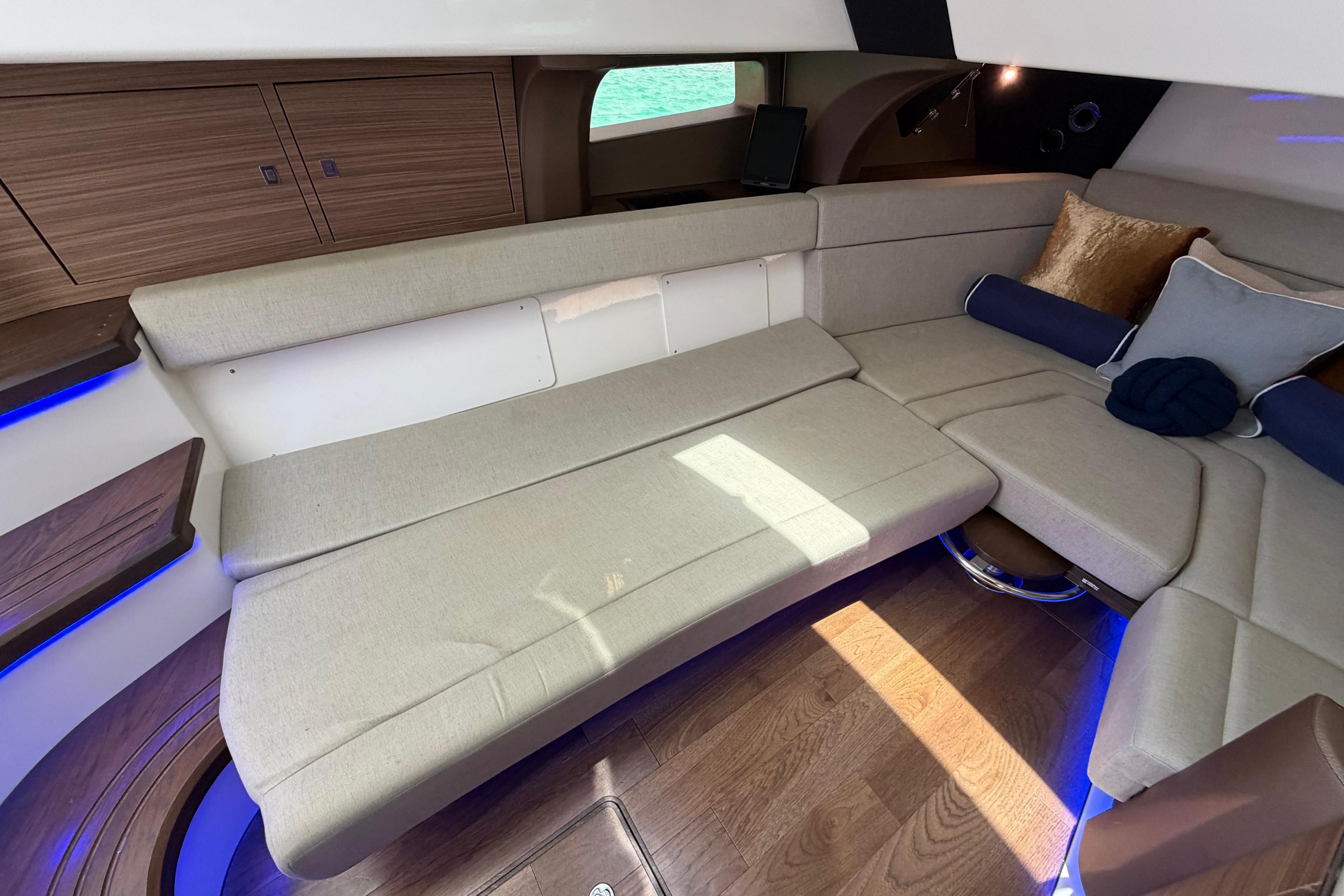 Luxurious interior of 2019 Boston Whaler 420 Outrage with plush seating and ambient lighting.