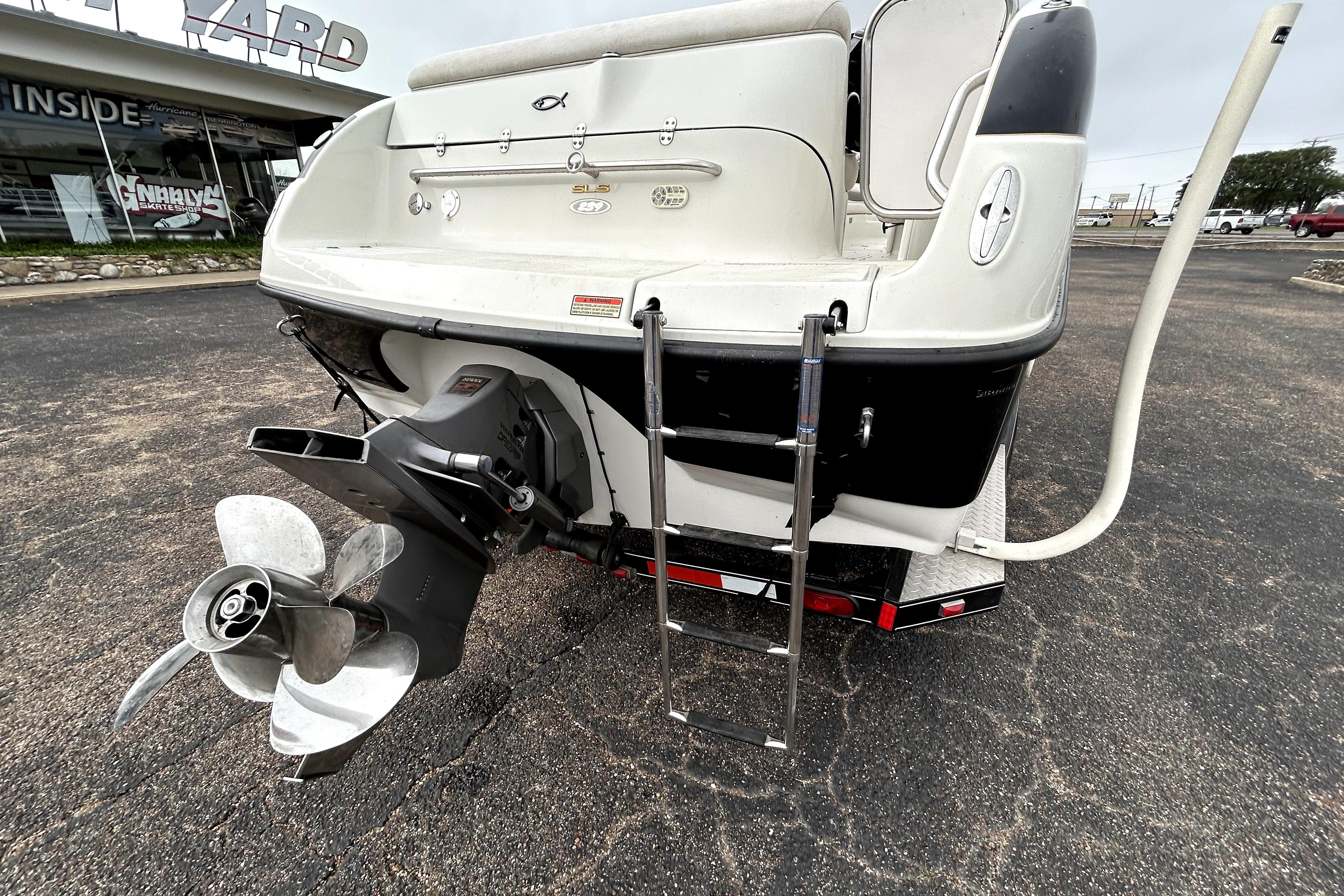 Rear view of 2001 Crownline 239 DB boat with propeller and ladder.
