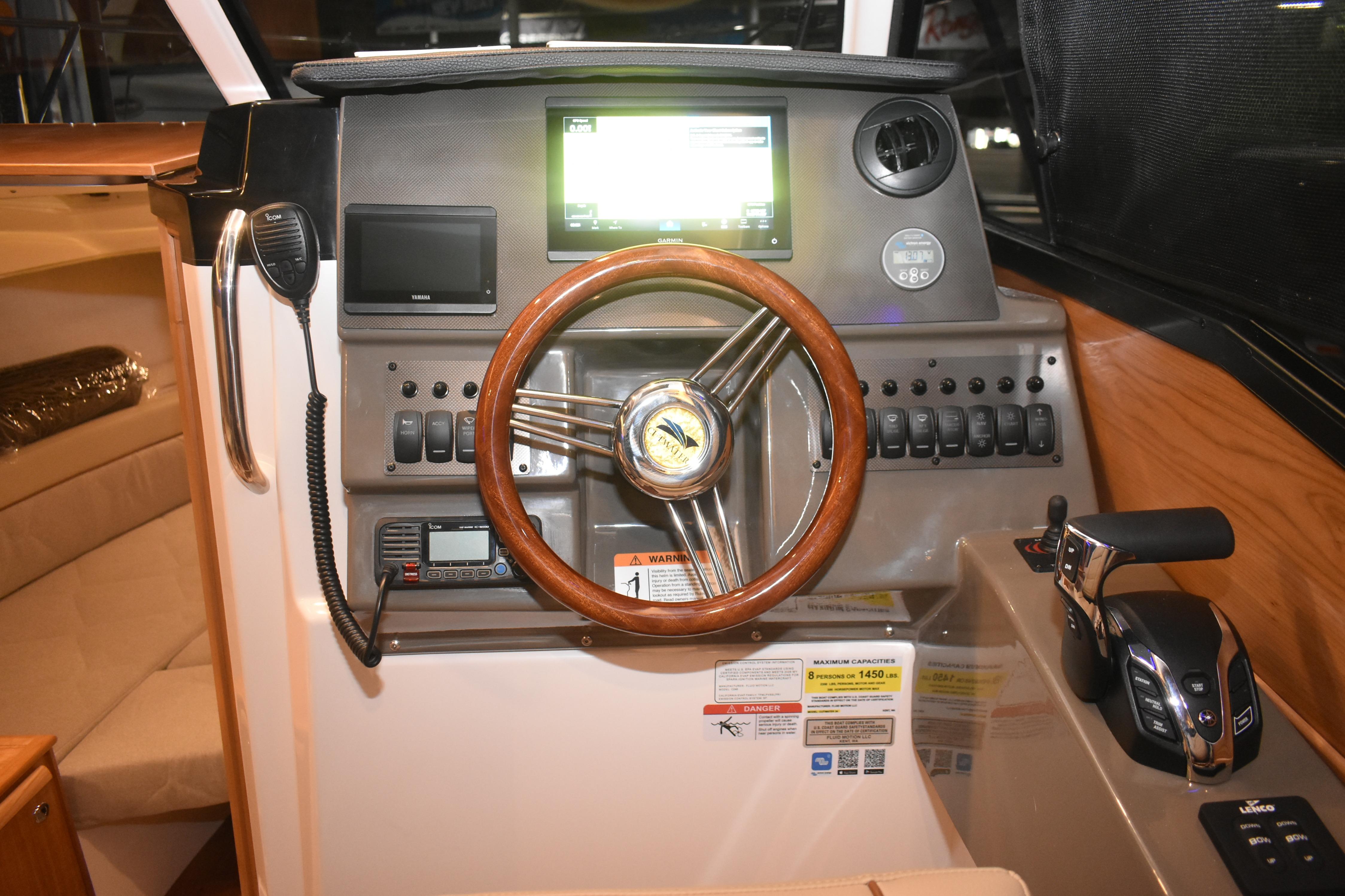 2026 Cutwater C-248 Coupe helm with wood steering wheel and modern controls.