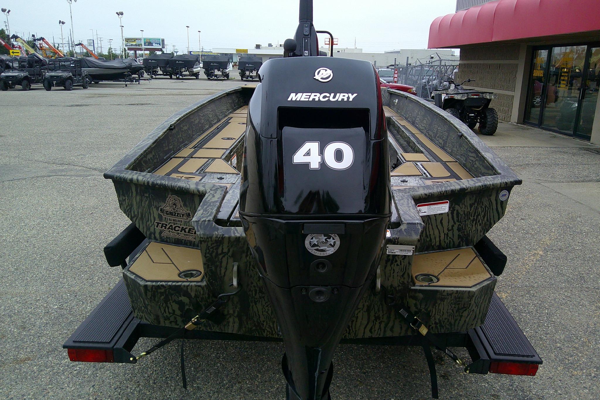 2026 Tracker Grizzly 1756 T Marsh boat with Mercury 40 engine in outdoor showroom.
