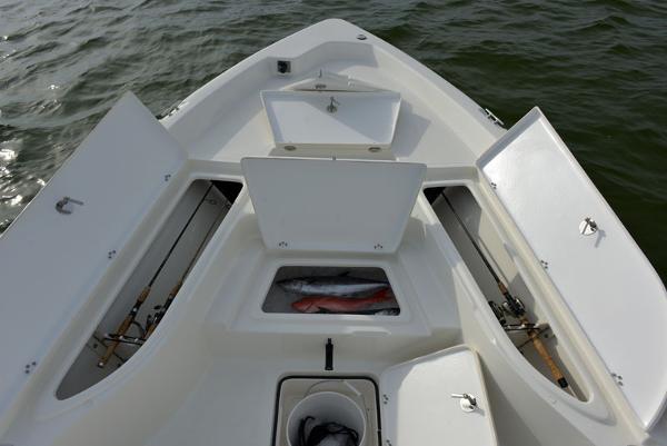 Manufacturer Provided Image: 2015 NauticStar 224 XTS boat with open storage compartments and fish in the cooler.