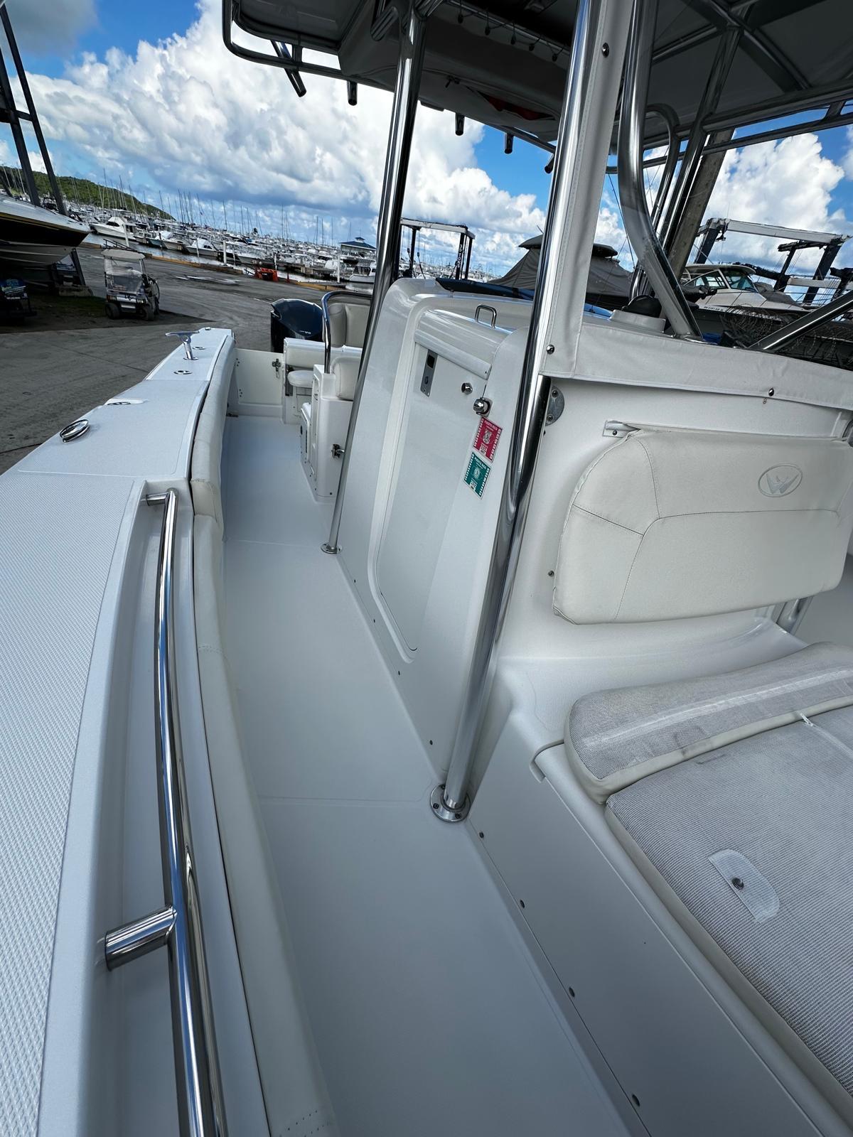 2009 Southport 28 Center Console boat, white interior, docked with clear sky background.