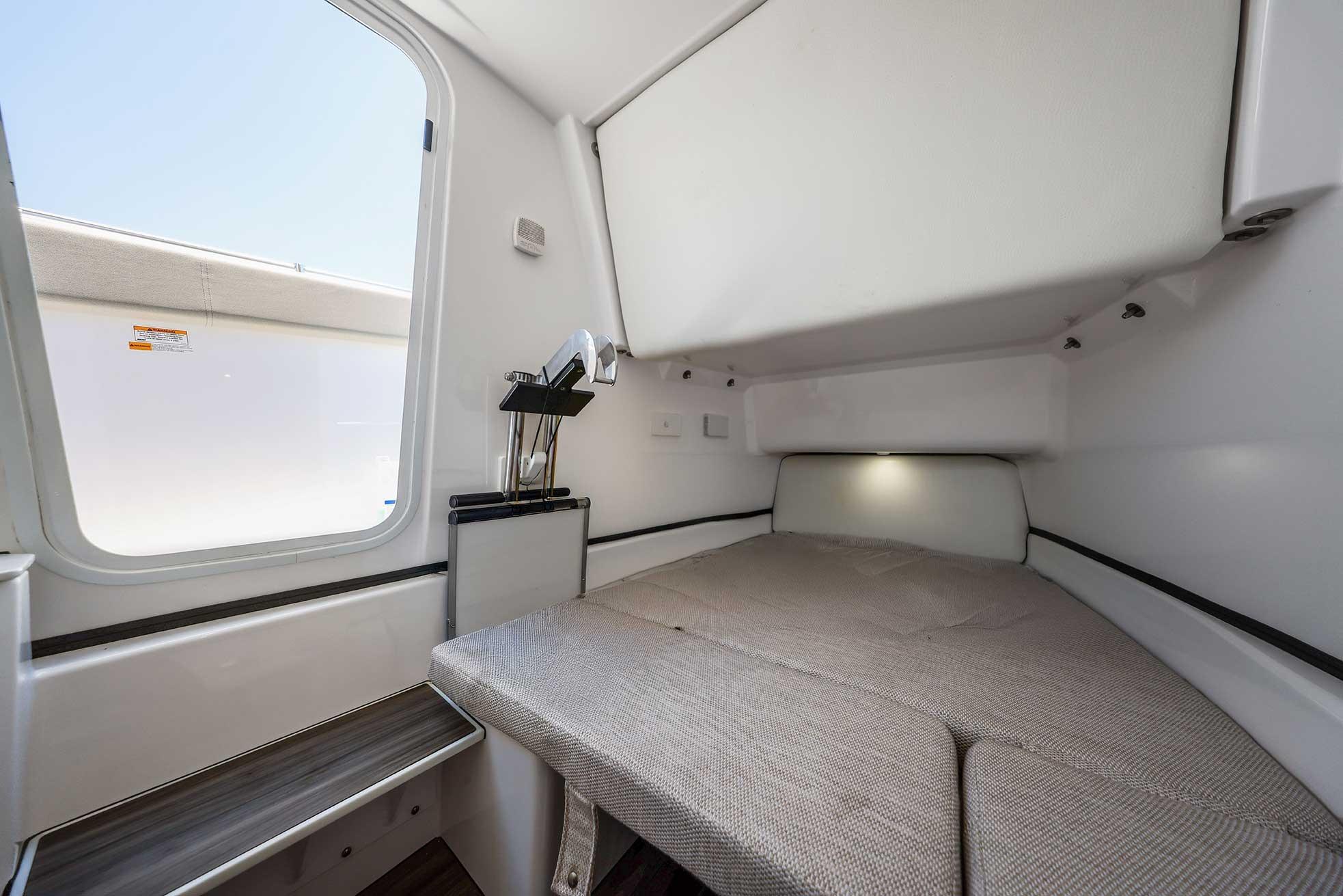 2024 Sportsman Open 352 Center Console cabin interior with bed and window view.