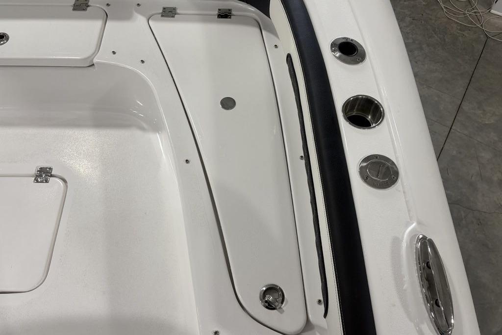 2026 Tidewater 2300 Carolina Bay boat deck with storage compartments and cup holders.