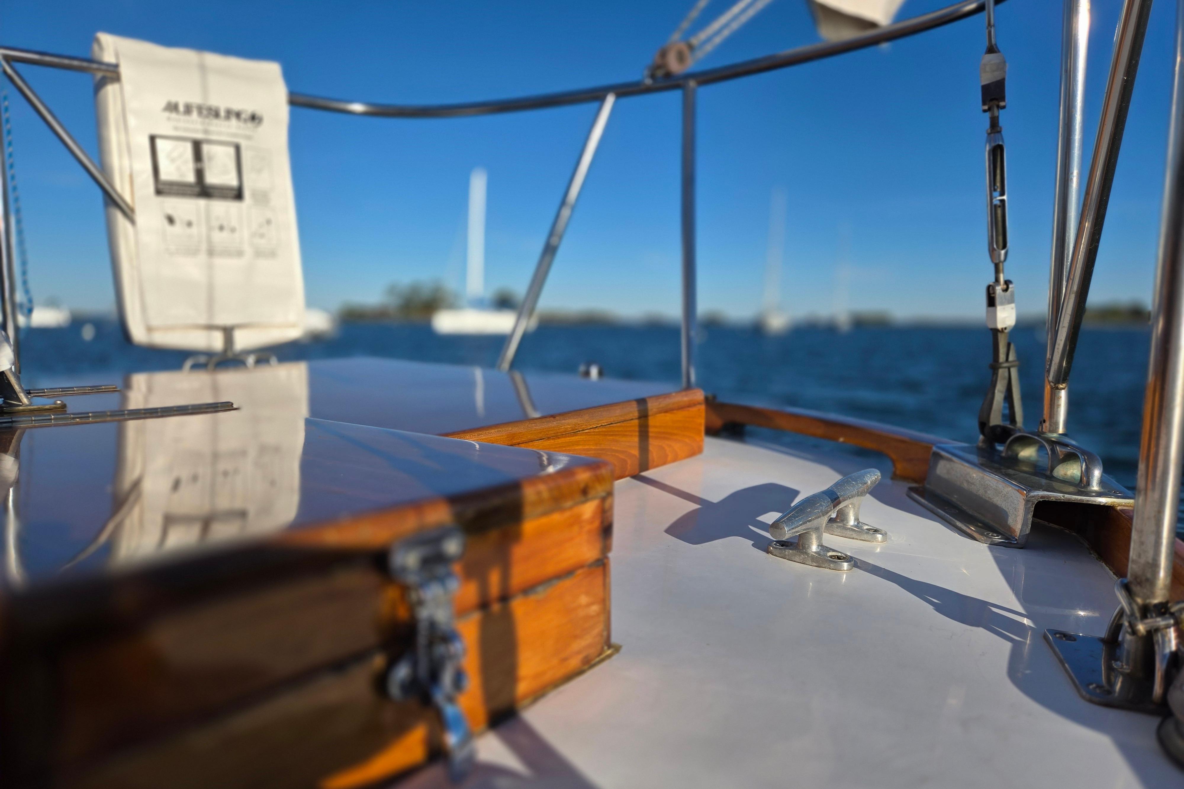 1970 Hinckley Bermuda 40 sailboat deck with polished wood and ocean view.