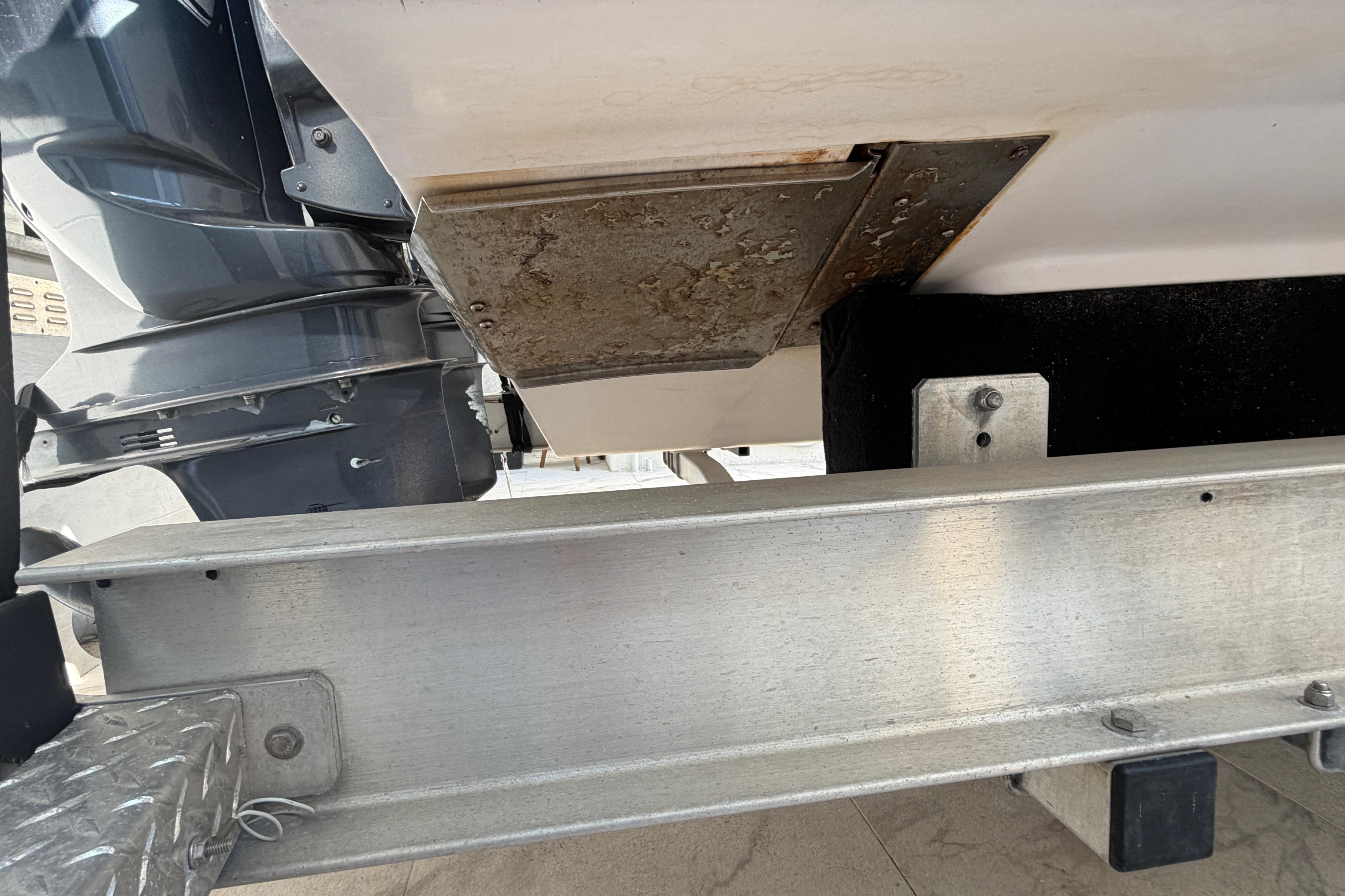 2004 Grady White 273 boat underside with visible engine and metal components.