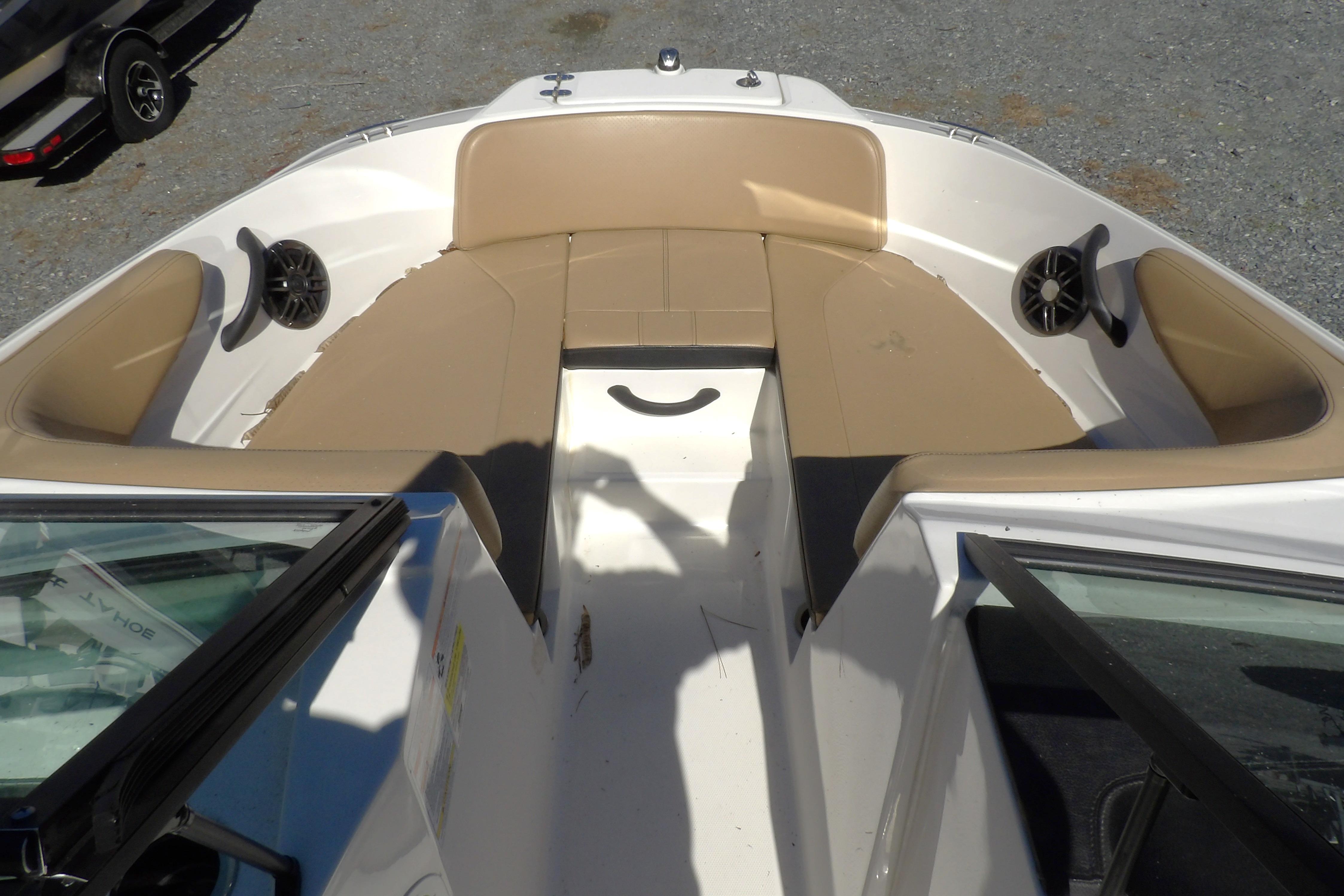 2023 Searay 210 SPO boat interior with tan seating and speakers.