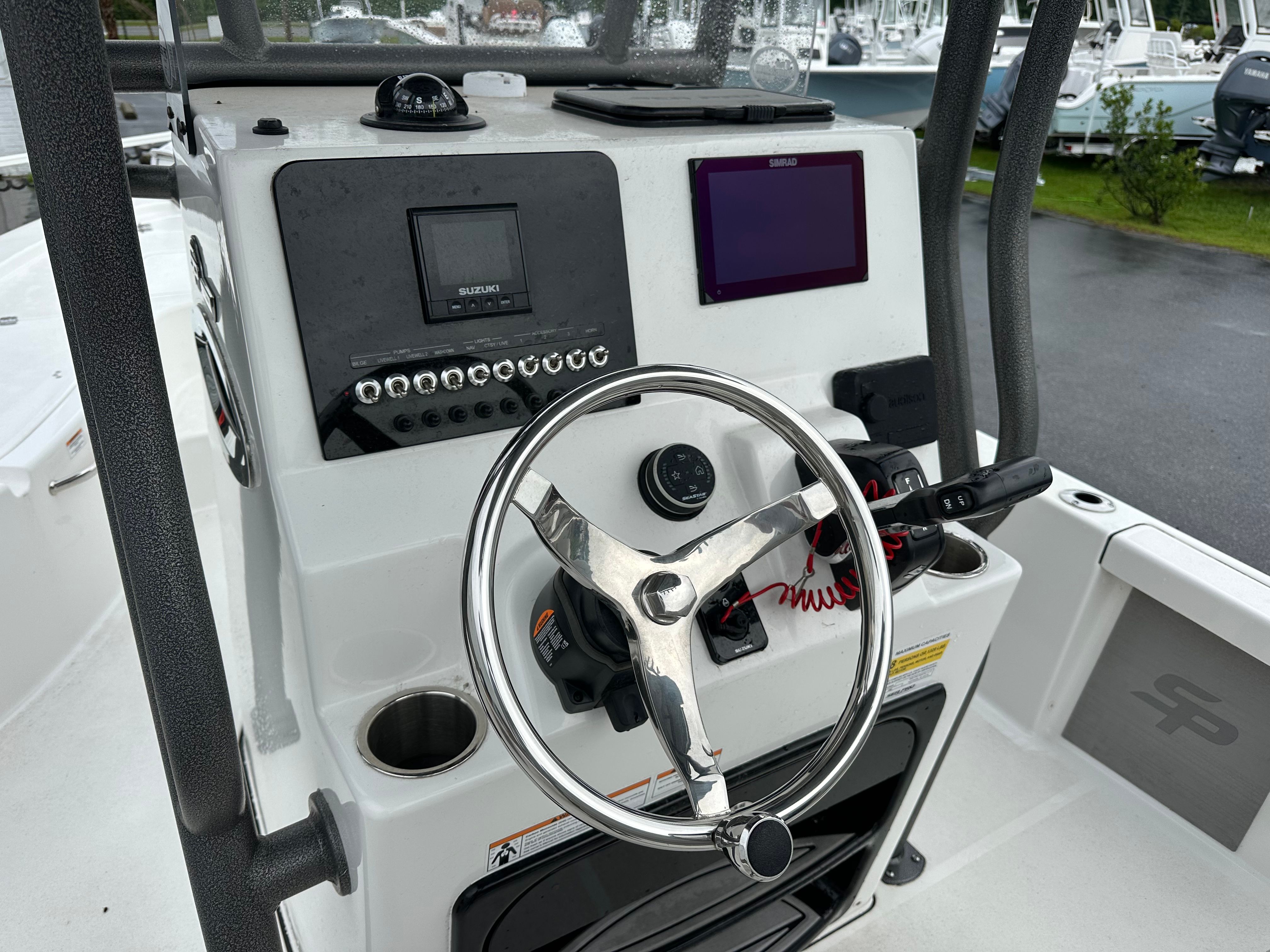 The image shows the helm of a Sea Pro 230 DLX boat with modern instruments.