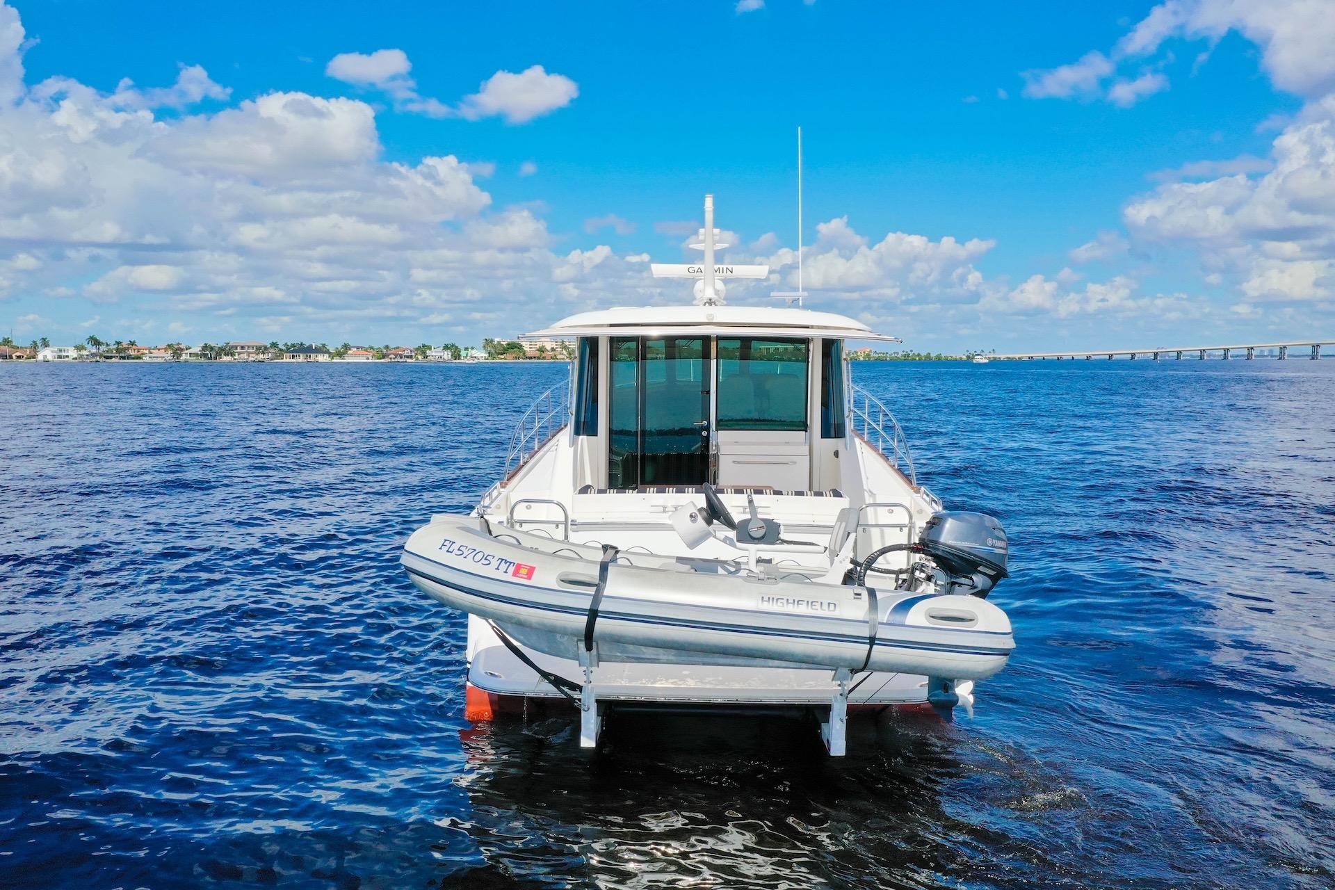 2019 Sabre 45 Salon Express yacht on open water under blue sky.