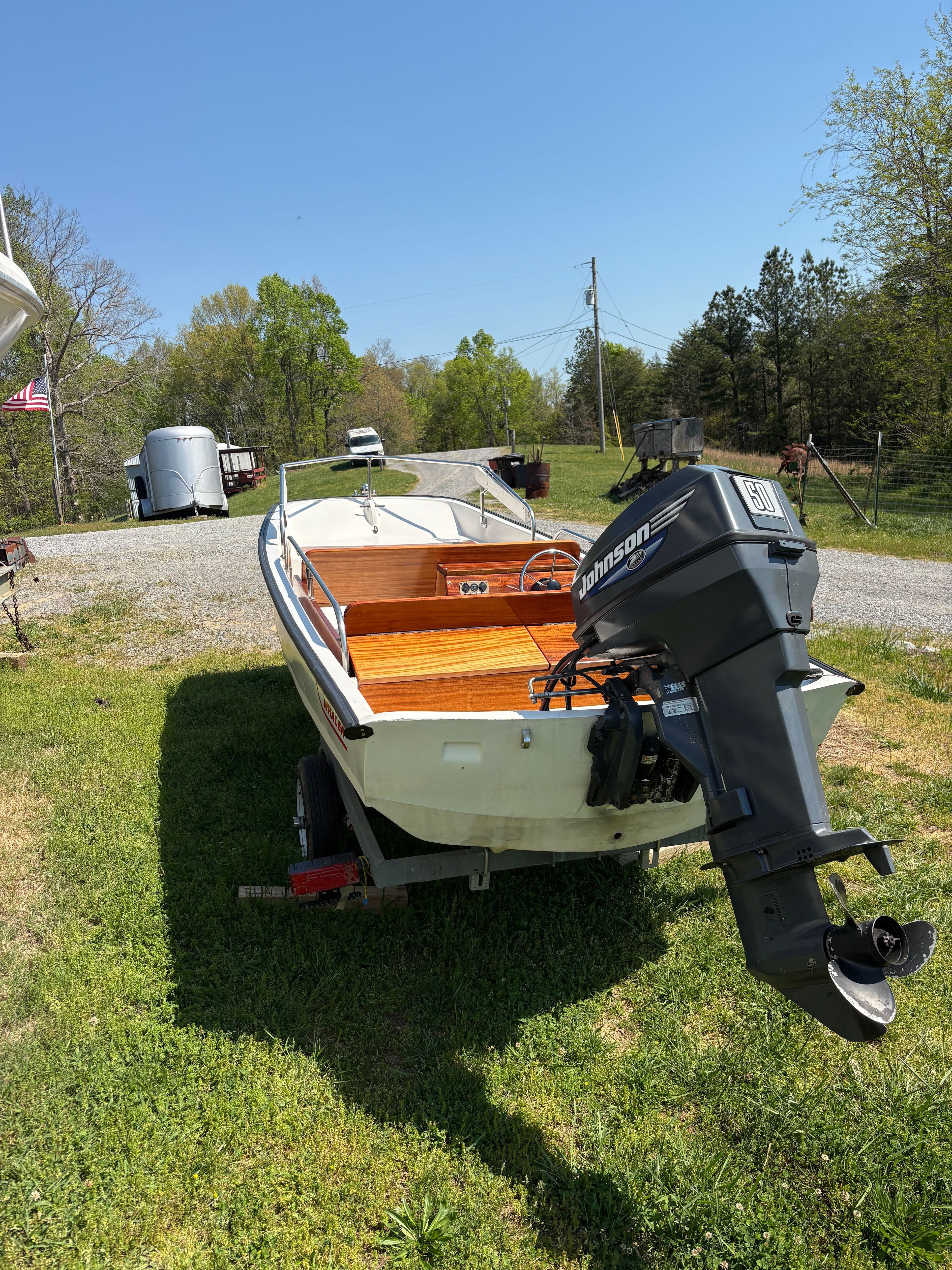 1977 Boston Whaler 13 boat with Johnson outboard motor on trailer.