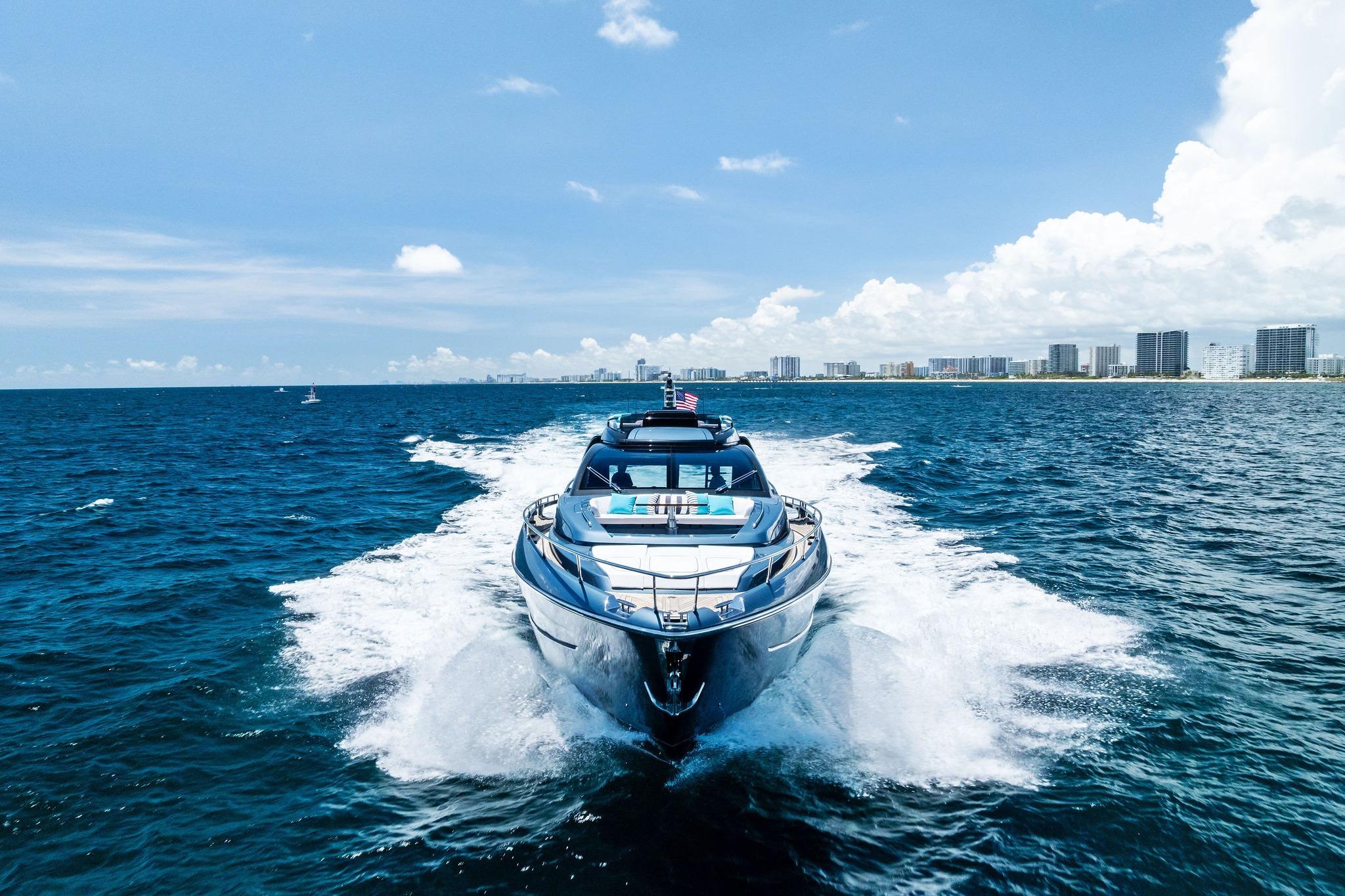 2024 Riva 76 PERSEO Super yacht cruising on open sea with city skyline backdrop.