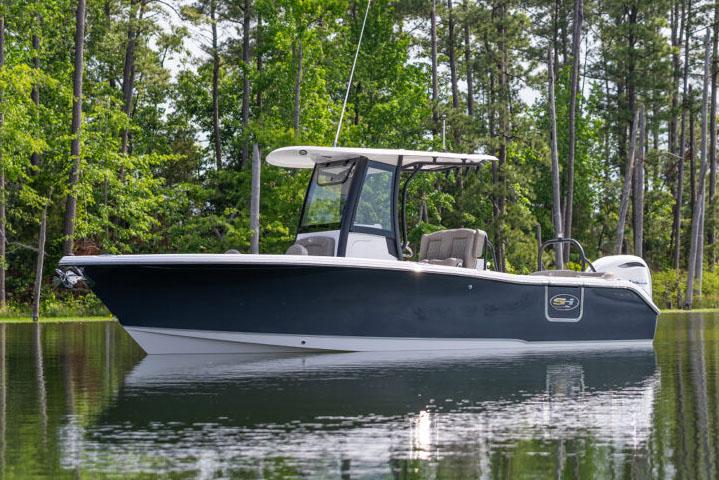 Manufacturer Provided Image: 2026 Sea Hunt Ultra 255 SE boat on a calm lake surrounded by trees.