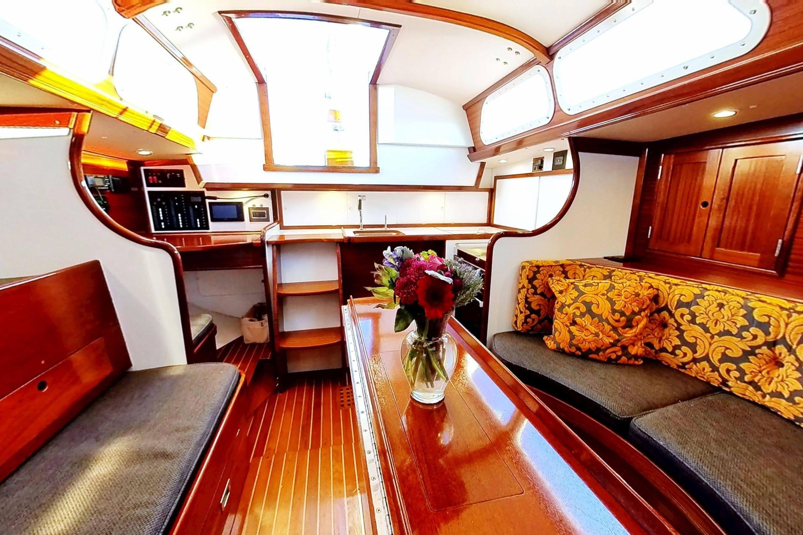 Luxurious interior of a 1970 Hinckley Bermuda 40 yacht with elegant wood finishes.
