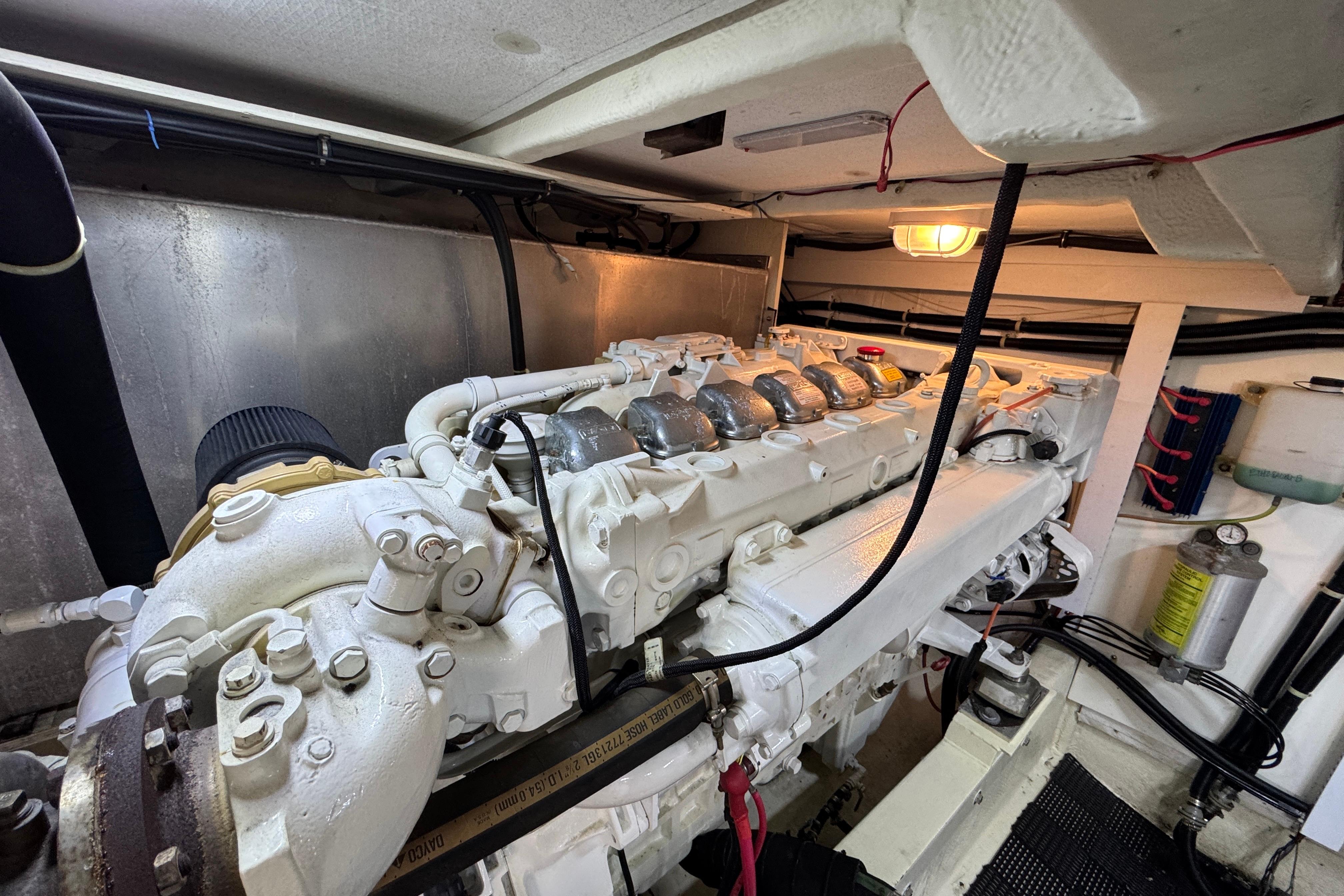 Engine room of 1998 Bayliner 5788 Pilot House Motoryacht, showcasing detailed machinery.