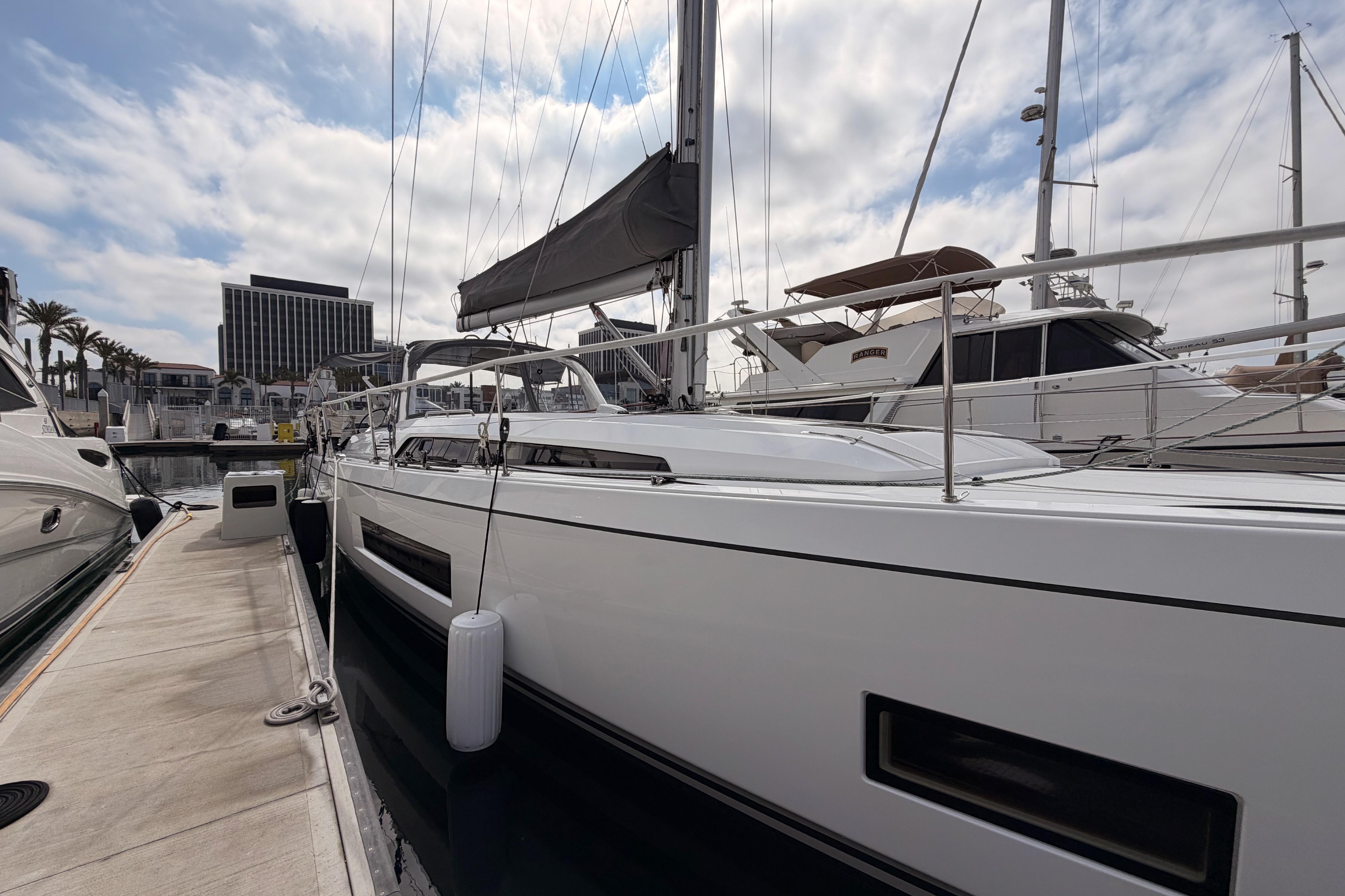 2020 Beneteau Oceanis 46.1 sailboat docked at marina under cloudy sky.