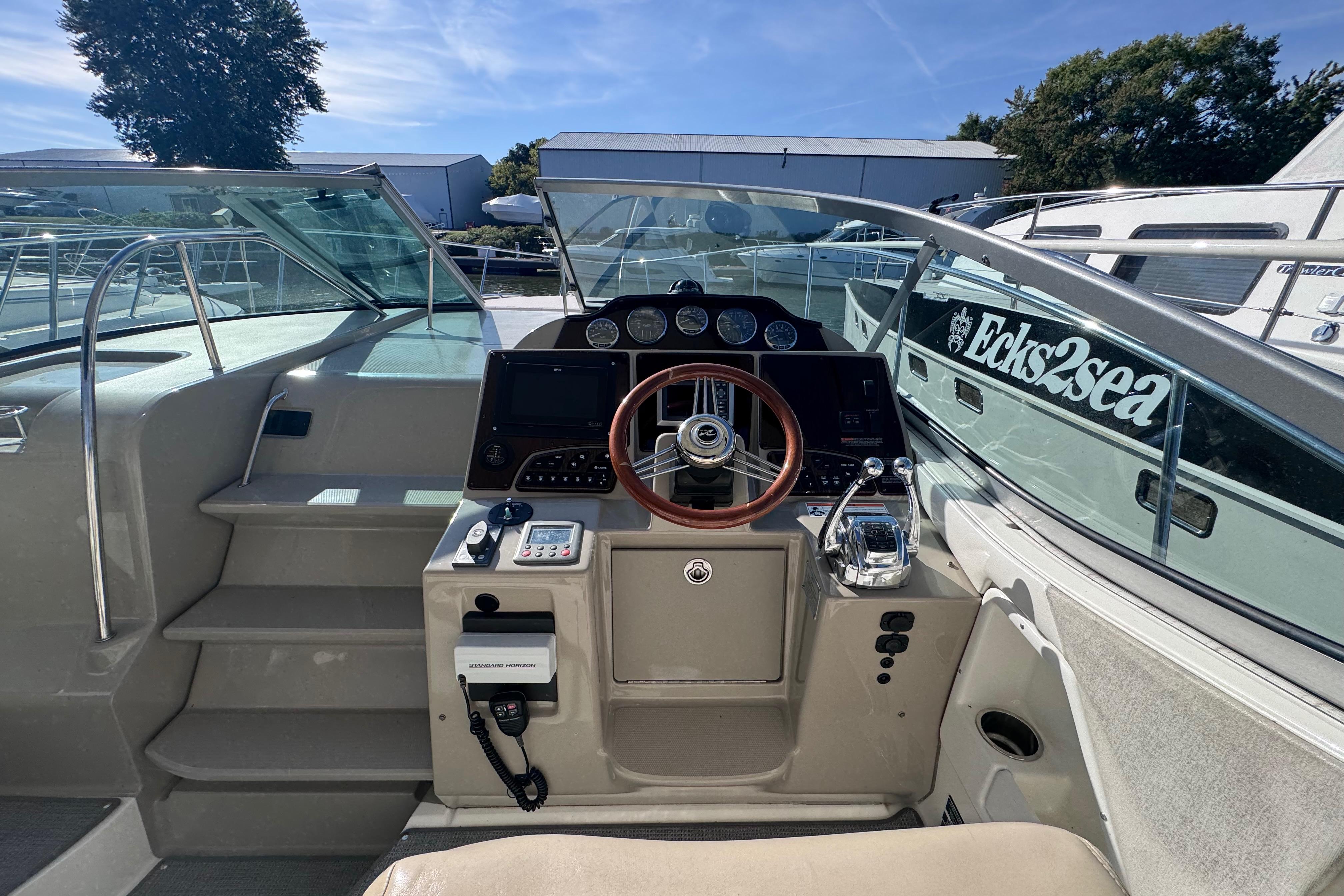 2008 Sea Ray 350 Sundancer helm with steering wheel and control panel.