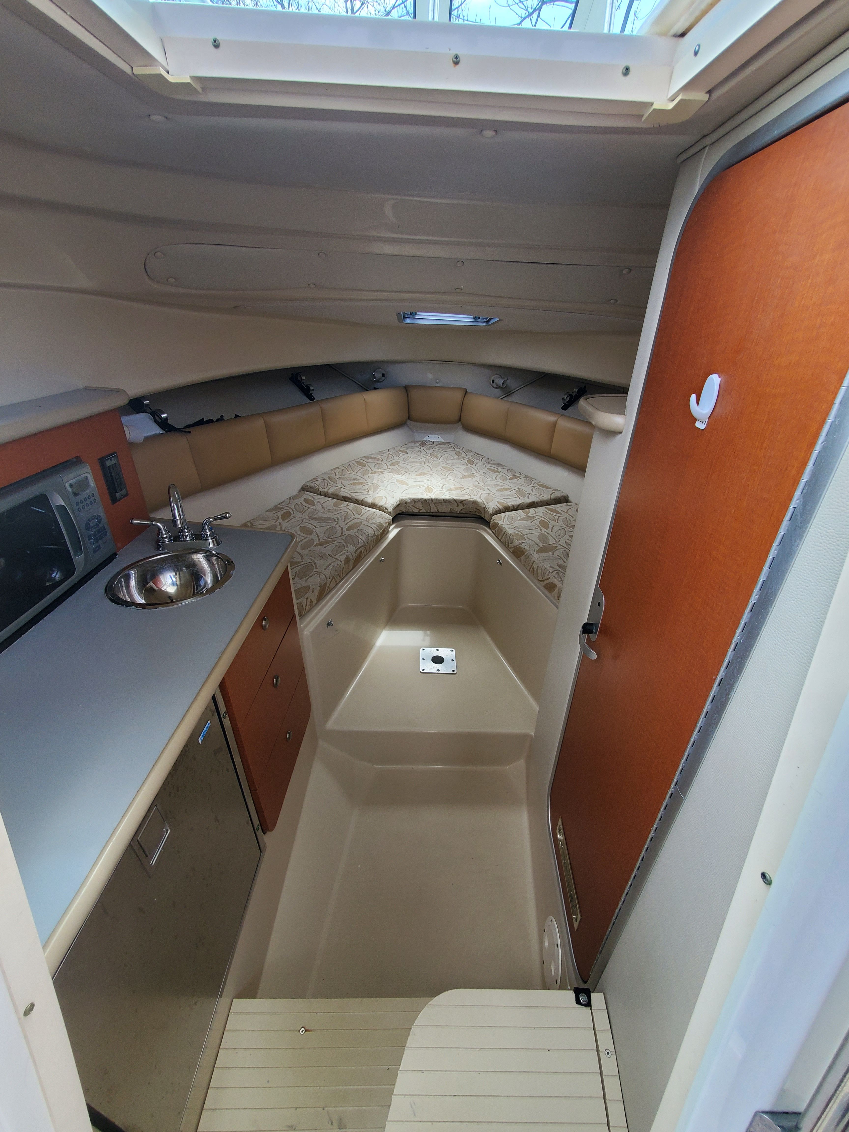 Interior of 2005 Robalo R265 Walkaround with kitchenette and sleeping area.