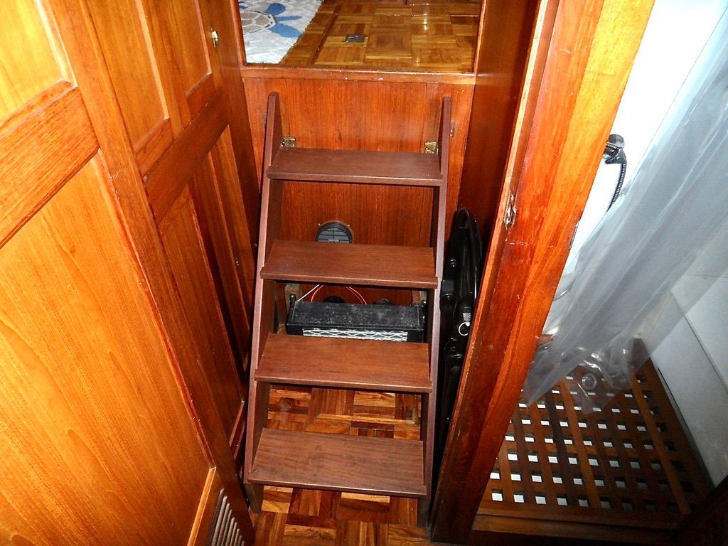 Wooden interior stairs on a 1976 CHB Trawler boat.