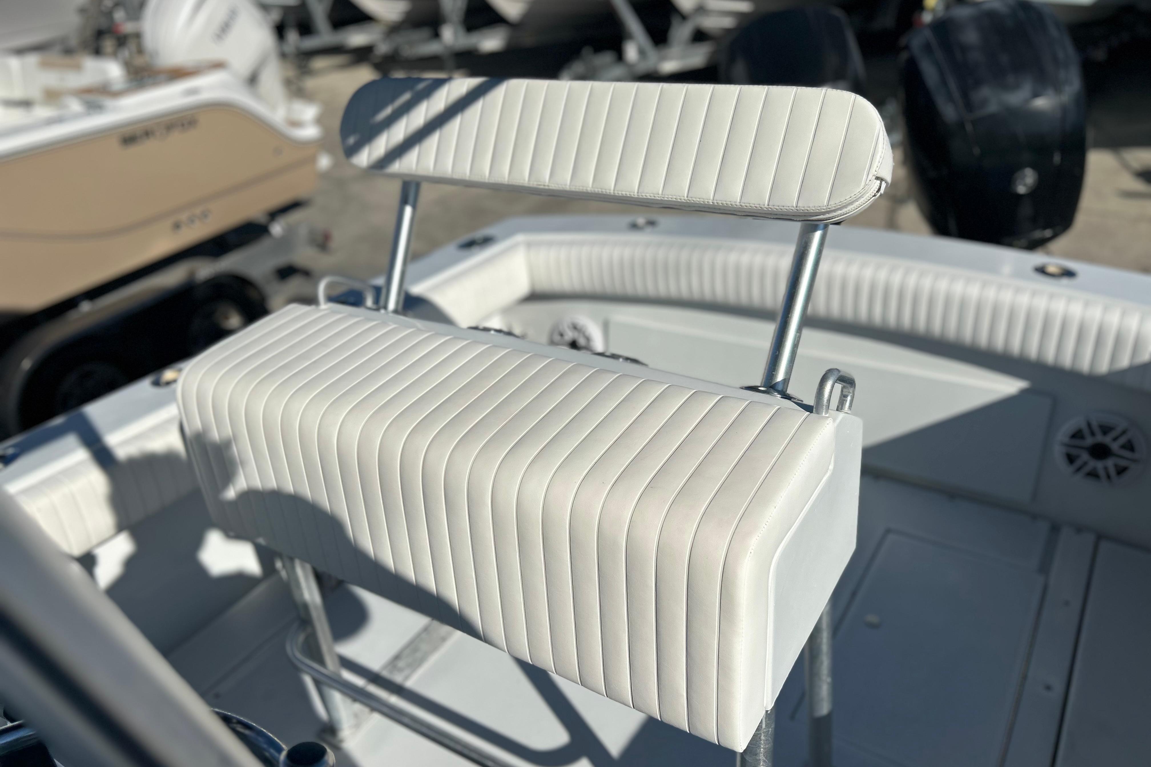 1991 Contender 25 Open boat with white cushioned seating and stainless steel frame.