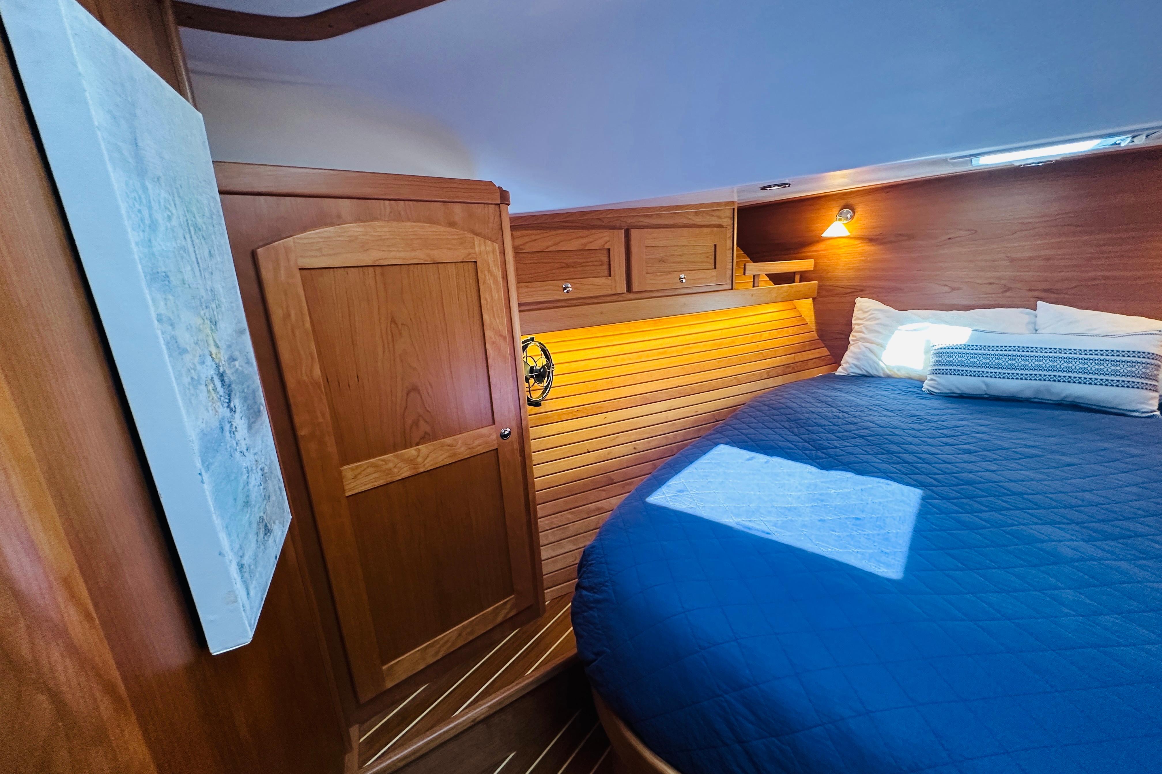 Luxurious cabin interior of 2025 Sabre 48 Salon Express with wooden finishes and cozy bedding.