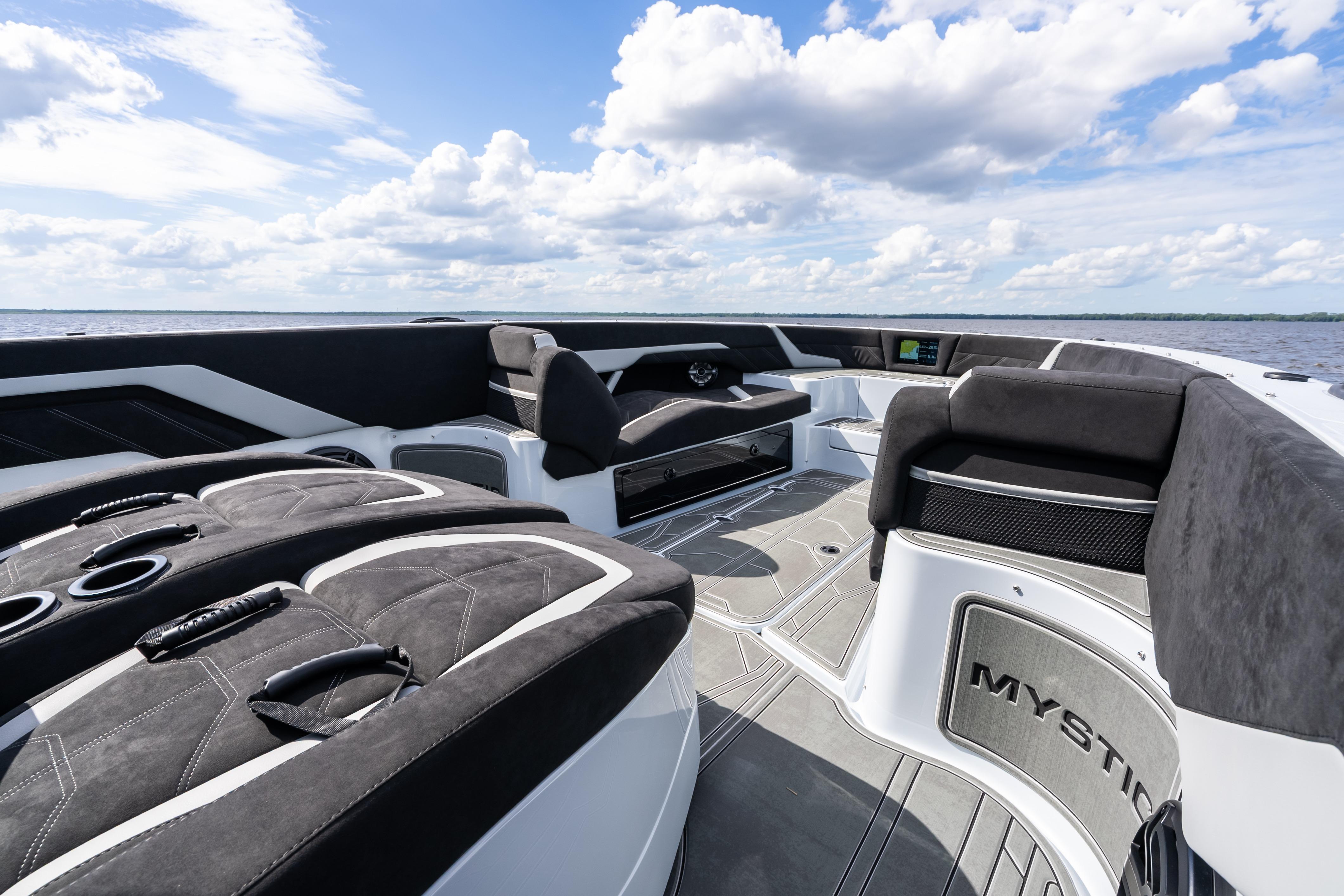 Luxurious 2027 Mystic Powerboats M4200 interior with plush seating and sleek design on open water.
