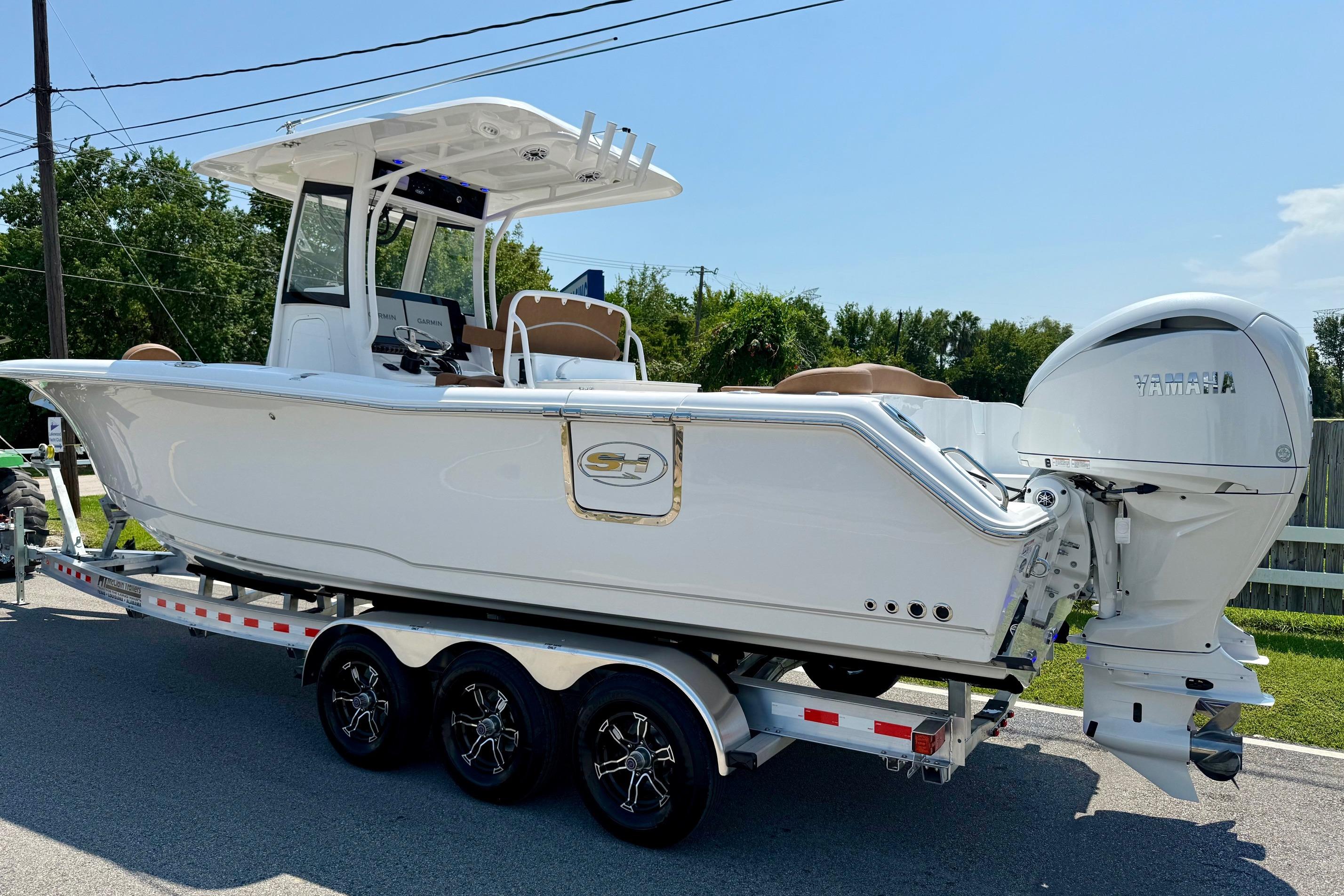 2026 Sea Hunt Ultra 305 SE boat on trailer, featuring Yamaha outboard engine.