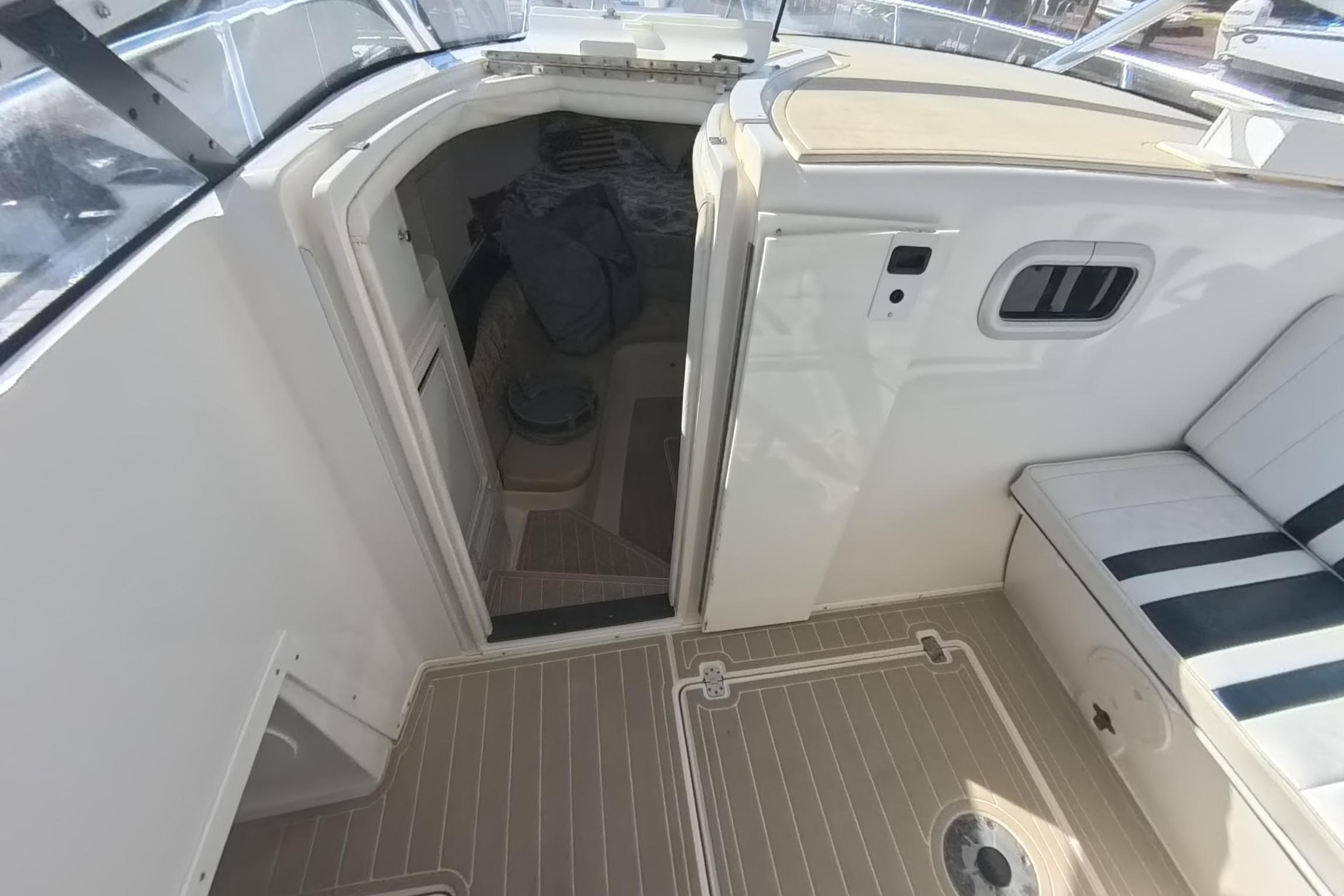 2005 Intrepid 348 Walkaround cabin entrance with seating and deck view.