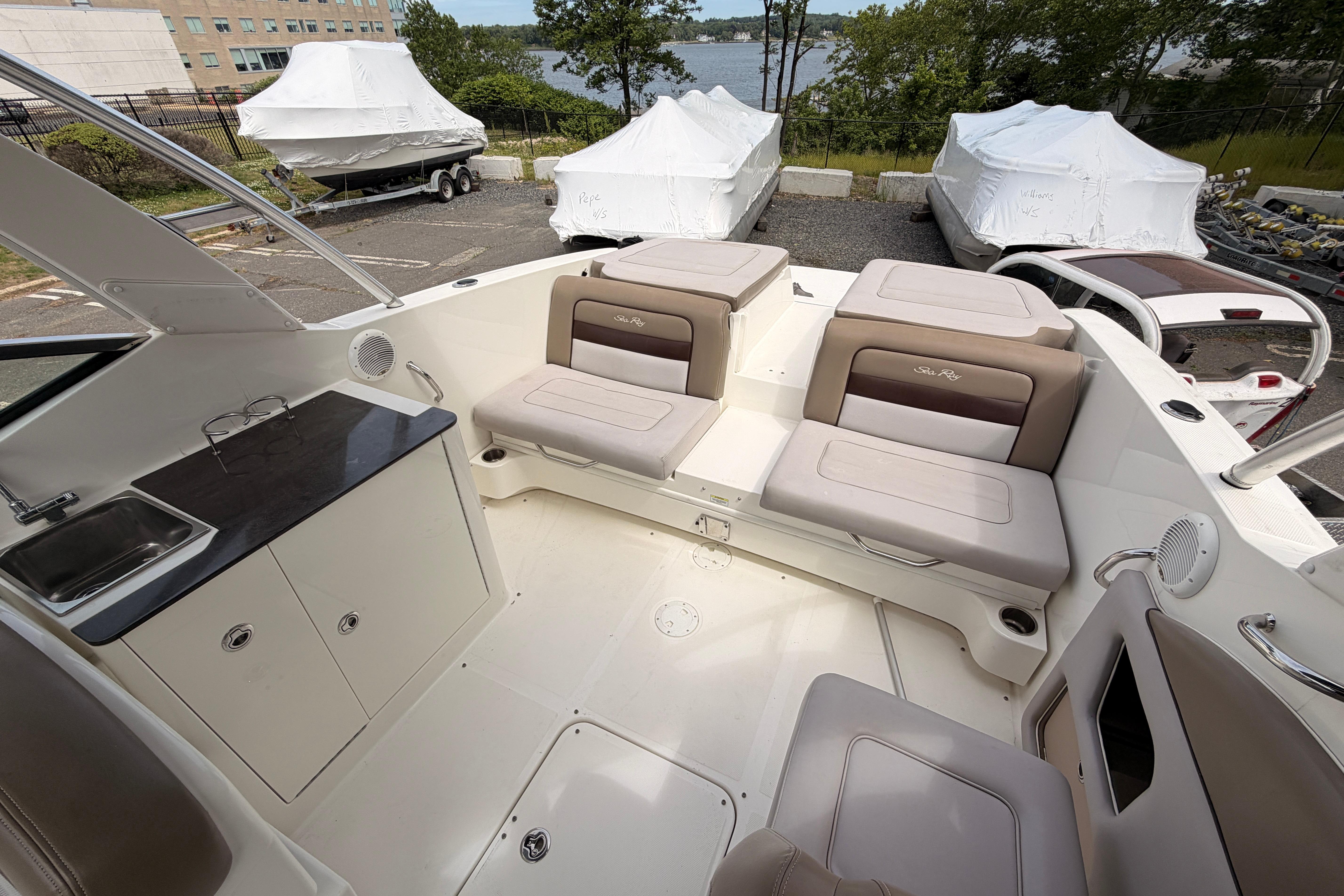 Interior of a 2011 Sea Ray 300 SLX boat with seating and kitchenette.