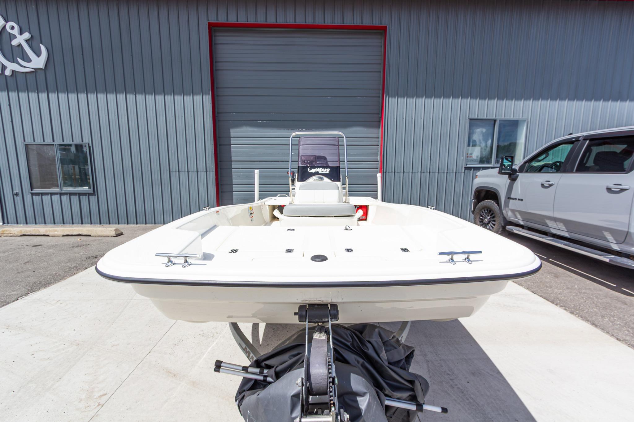 2020 Mako Pro Skiff 15 CC boat on trailer, parked outside a garage.