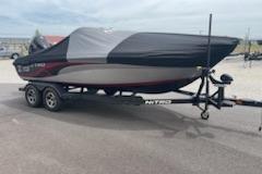 2023 Nitro ZV19 Sport boat on trailer, covered, parked outdoors.