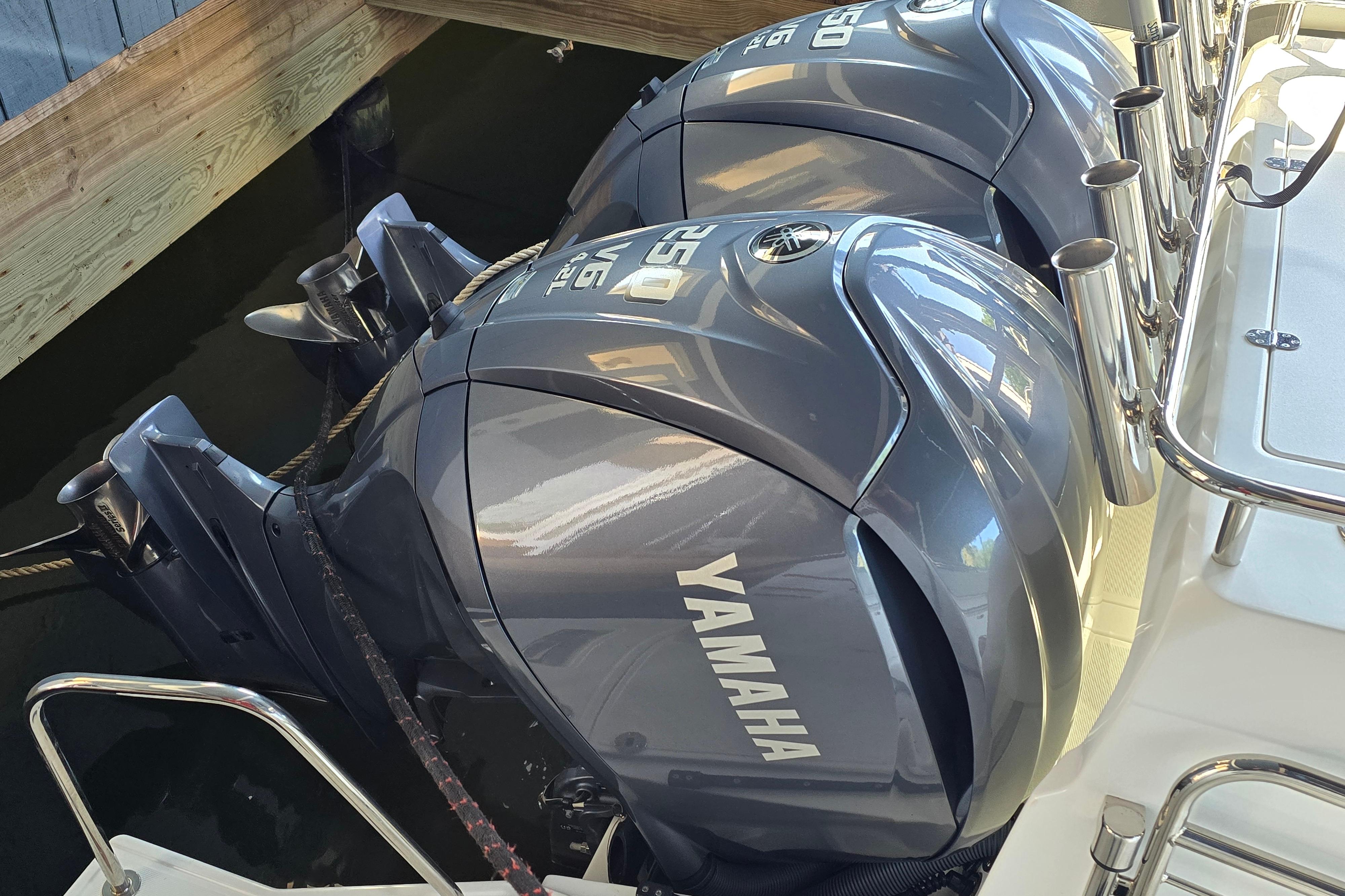 Two Yamaha outboard engines on a boat in the water.