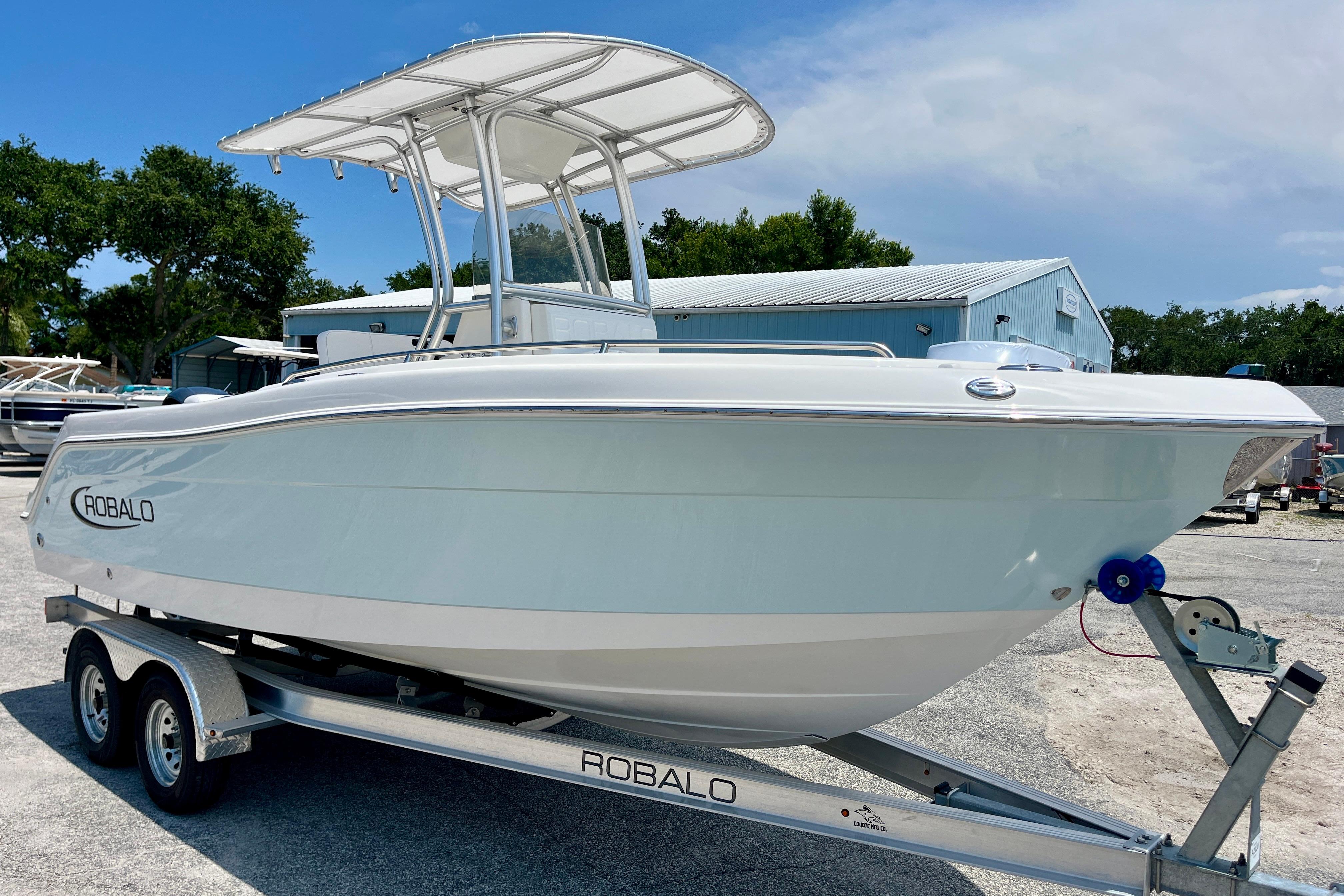 2016 Robalo R222 Center Console boat on trailer, parked outdoors.