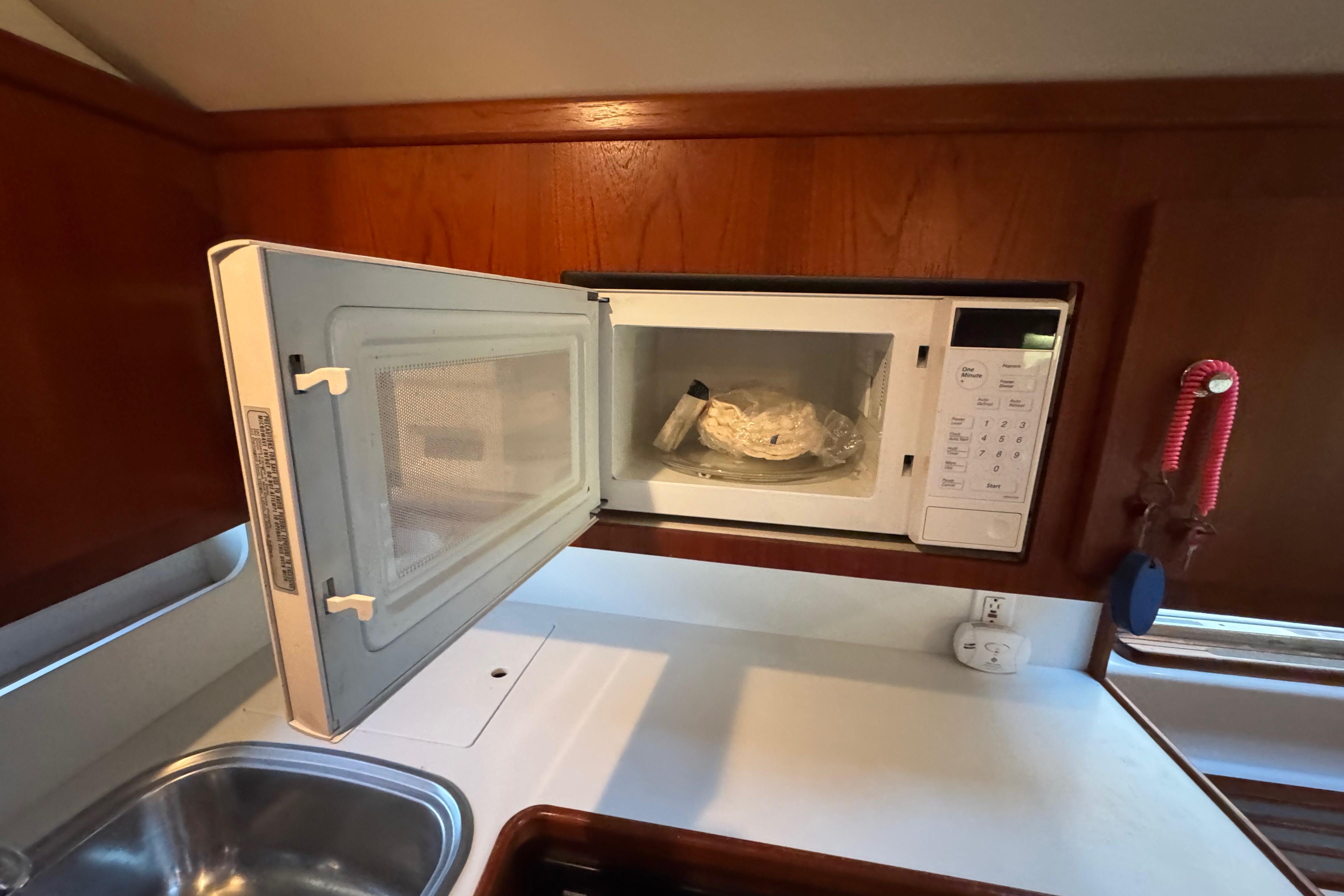 Microwave in Tiara 37 Open yacht kitchen, 2000 model, with wooden cabinetry.