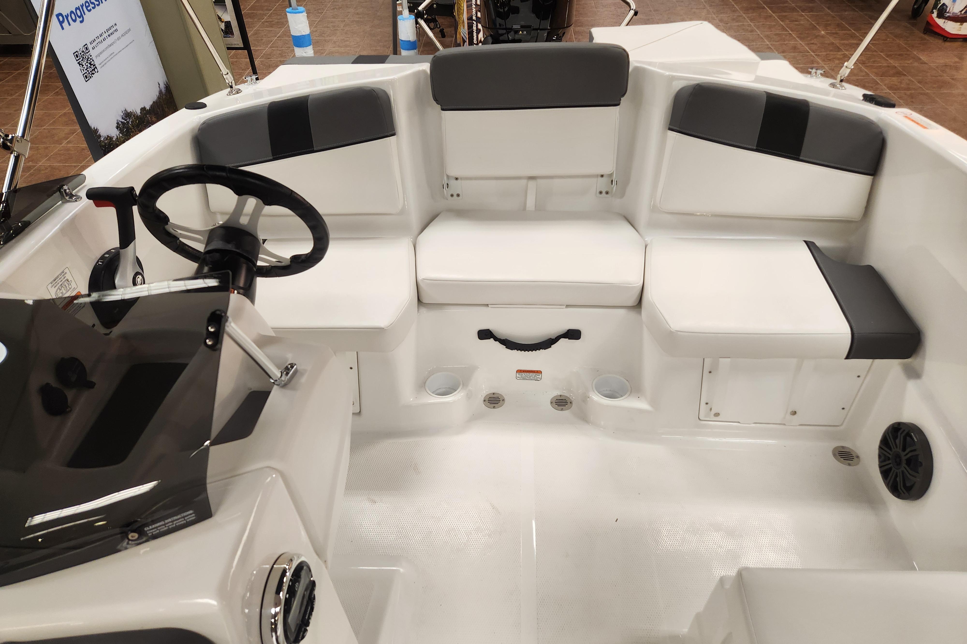 2026 Tahoe T16 boat interior with seating and steering wheel, showcasing modern design.