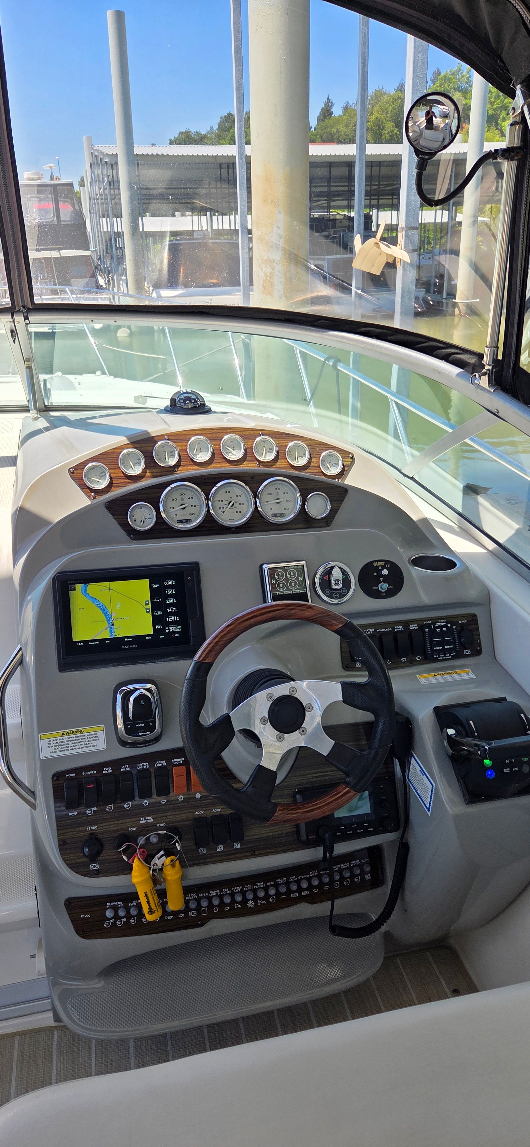 2012 Bayliner 335 Cruiser helm with instruments and steering wheel.
