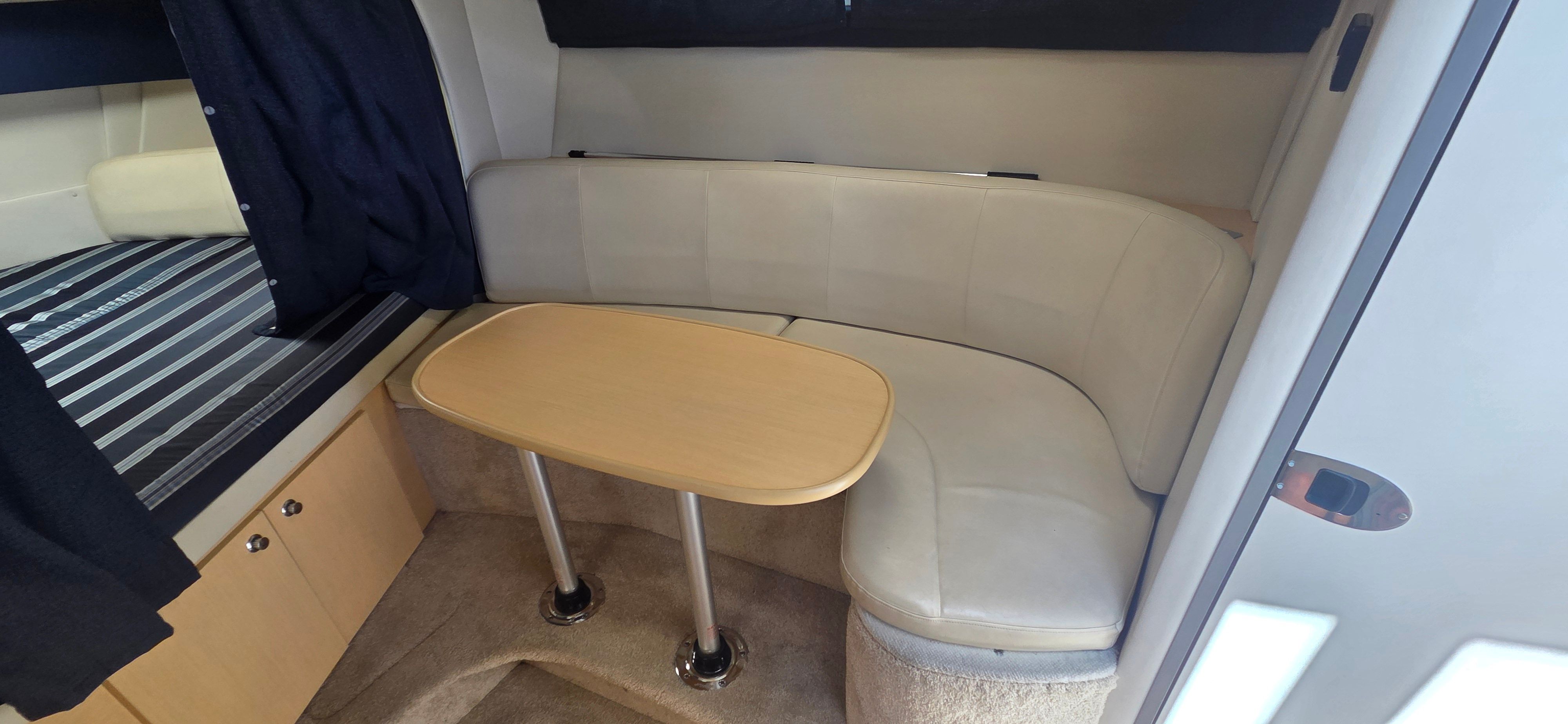 Interior of 2012 Bayliner 335 Cruiser with seating area and table.