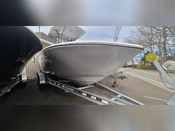 2023 Sea Born LX22 Center Console boat on trailer, parked outdoors.