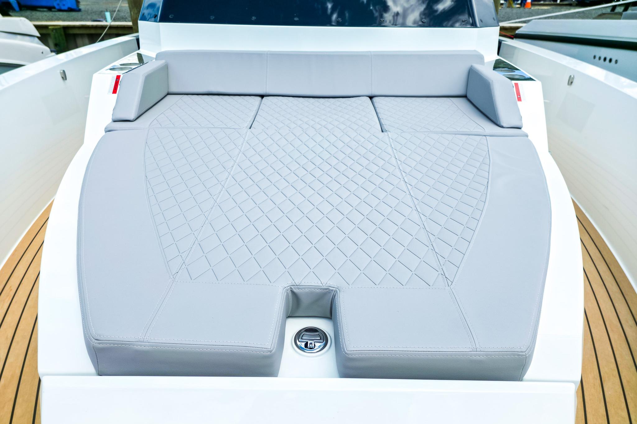 Luxurious sunbed on 2026 De Antonio Yachts D32, featuring elegant diamond-patterned upholstery.