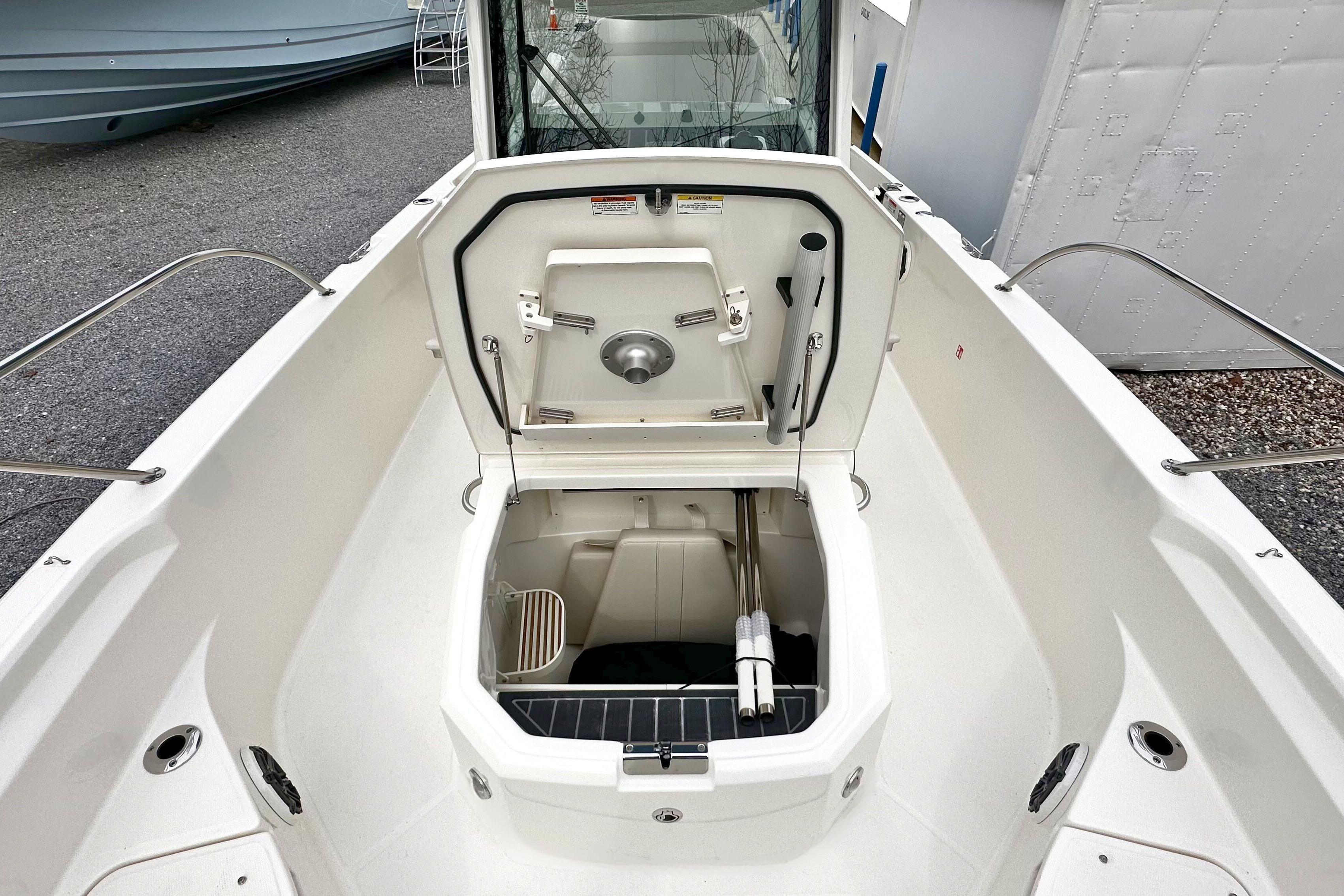 2026 Boston Whaler 280 Dauntless boat with open storage compartment, showcasing sleek design.