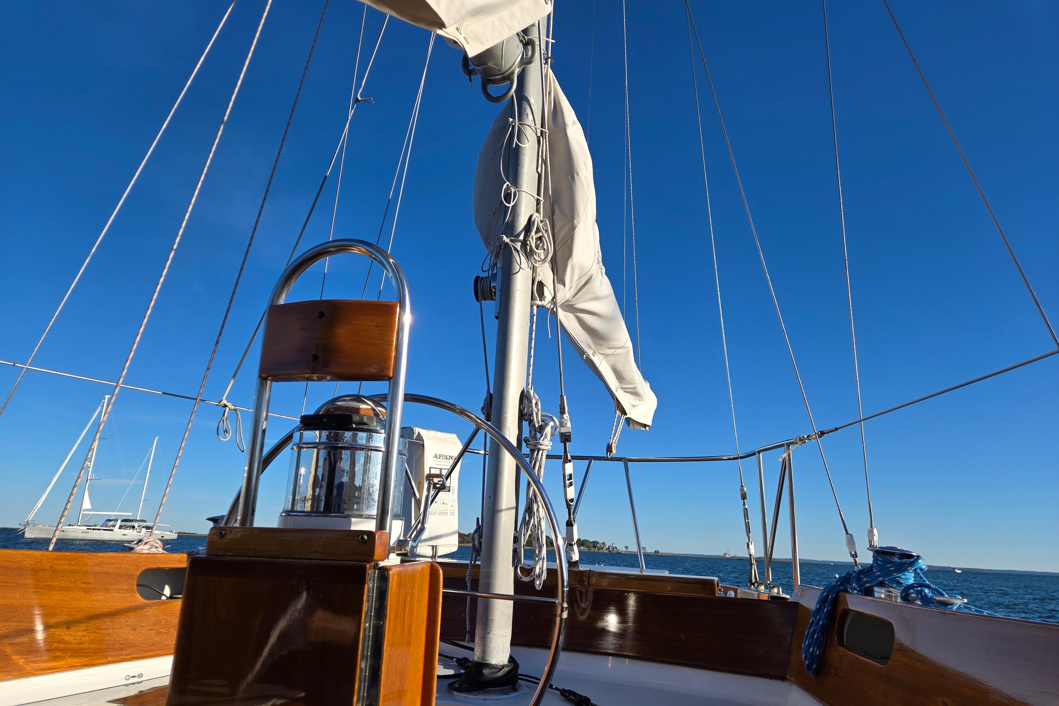 1970 Hinckley Bermuda 40 sailboat deck with clear blue sky and ocean view.