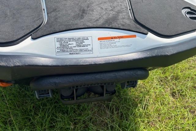 2010 Sea-Doo GTX 155 rear view on grass, showing warning label and platform.