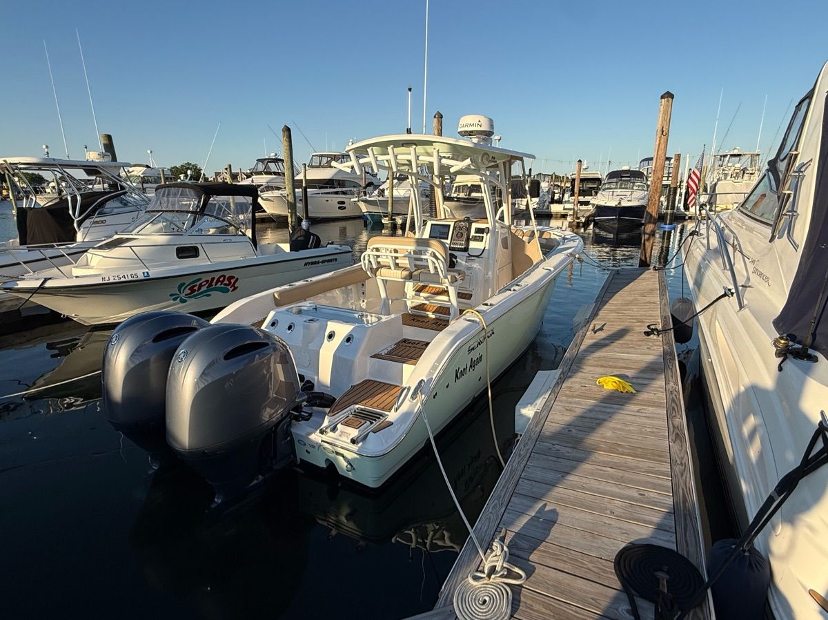 A 2017 Sea Fox Commander 266 docked. It features dual outboard engines.