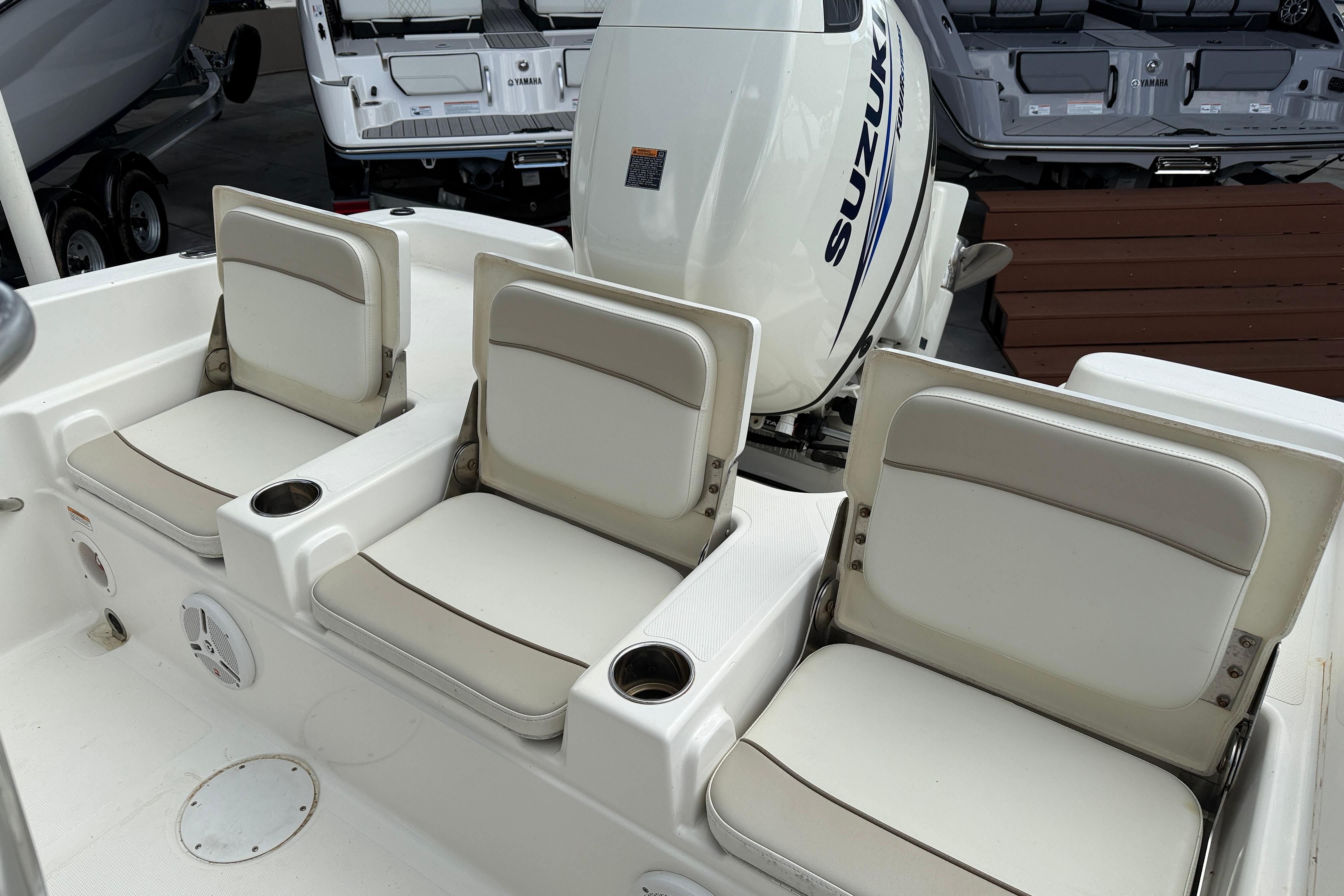 2015 NauticStar 231 Coastal boat seats with Suzuki outboard motor in background.