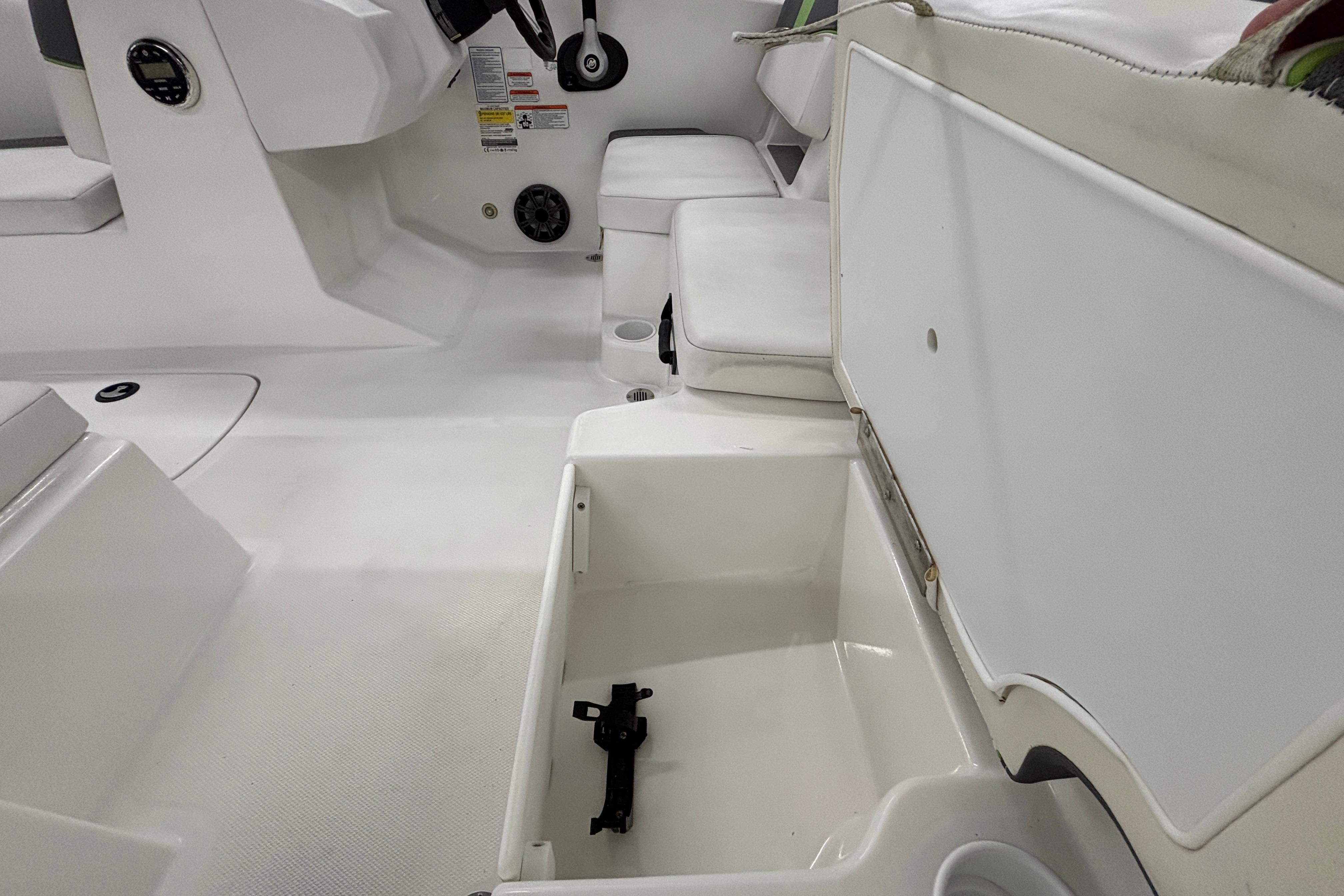 2024 Tahoe T18 boat interior with open storage compartment and seating area.