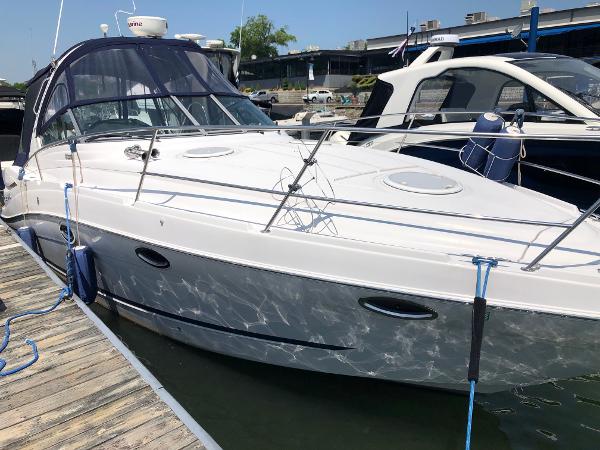 2008 Four Winns V338 docked at a marina.