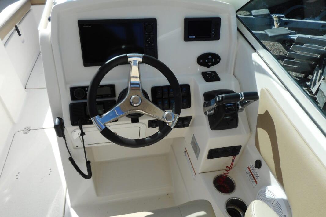 Helm of 2020 Sailfish 275 DC boat with steering wheel and control panel.