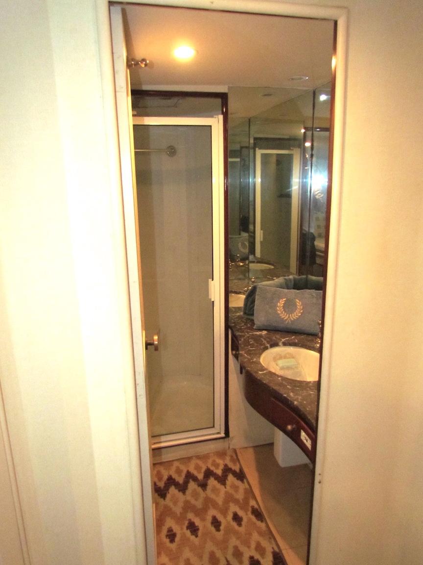 Bathroom interior of 1972 Hargrave 67 Motor Yacht with shower and sink.