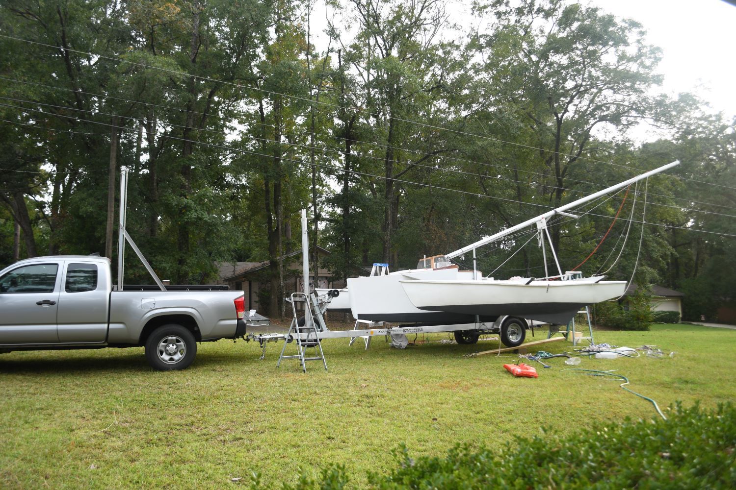 Silver truck towing Custom Strike 18 sailboat on trailer, 2020 model.