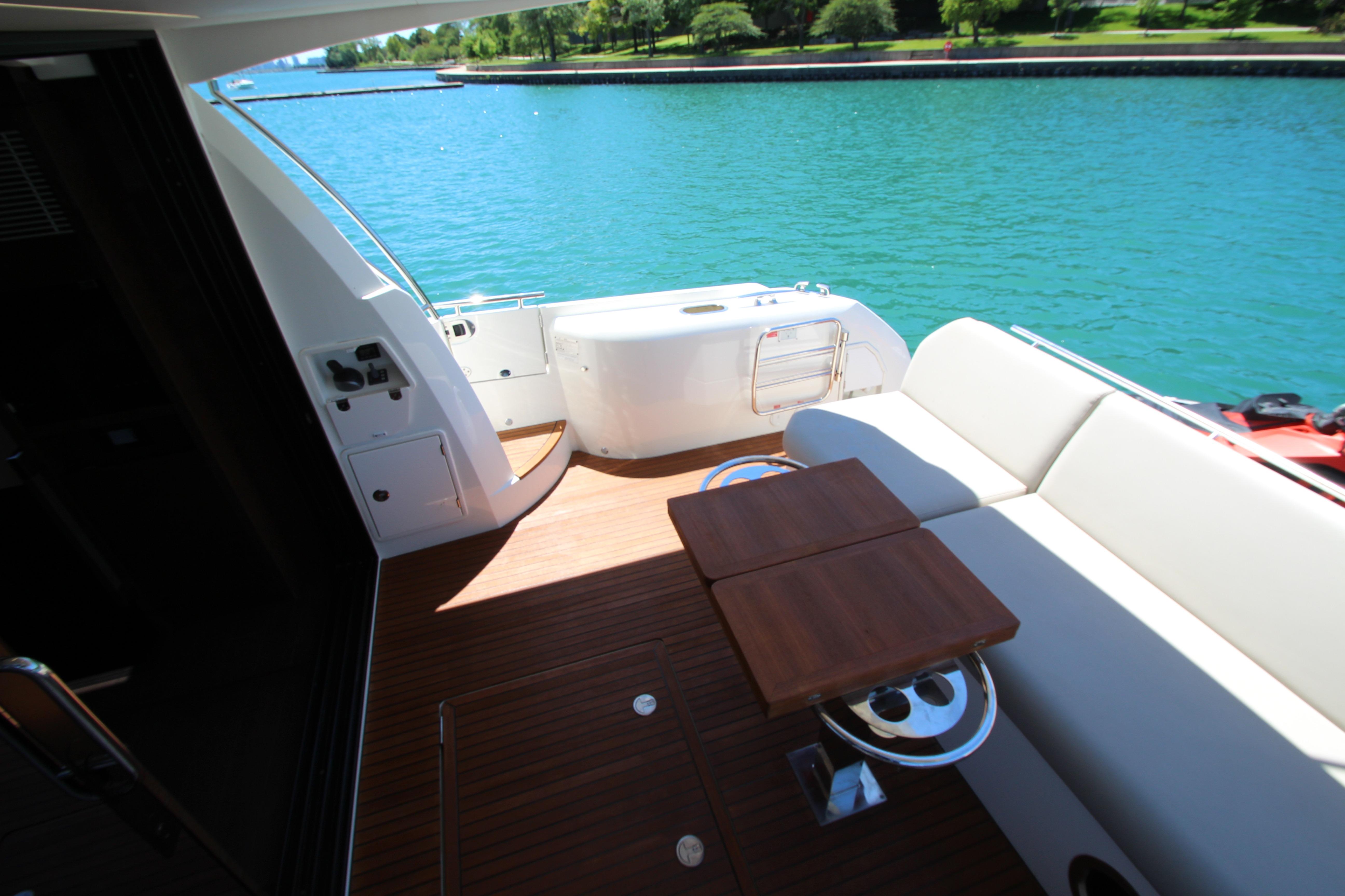 Luxurious 2022 Prestige 520 yacht deck with seating, overlooking serene blue waters.